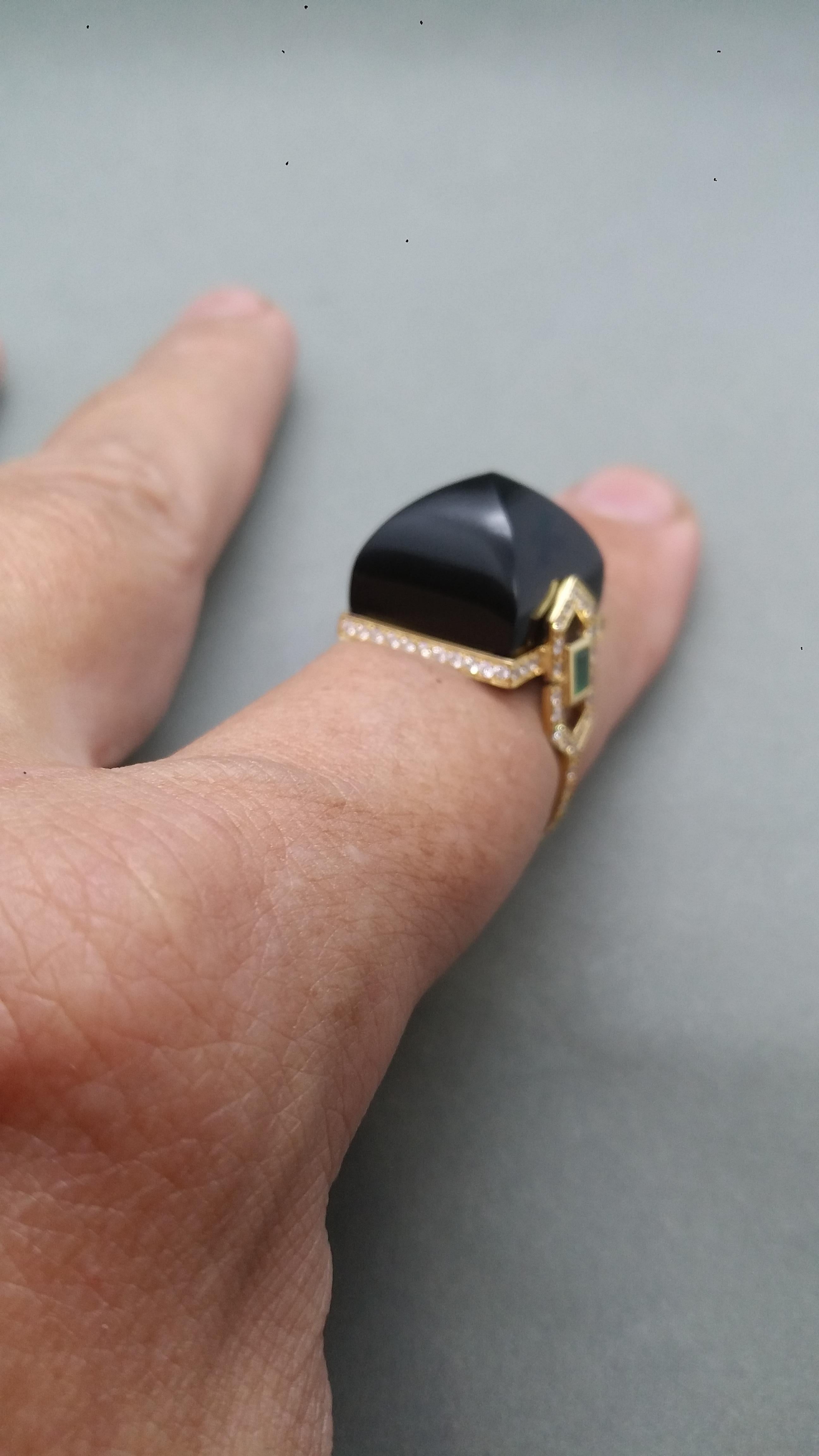 Unique and classic handmade Art Deco Style cocktail ring with a Black Onyx Pyramid measuring 16x16 mm set in a 14 kt yellow gold mounting,including full cut diamonds and 2 small Emerald baguettes on the sides.
In 1978 our workshop started in Italy