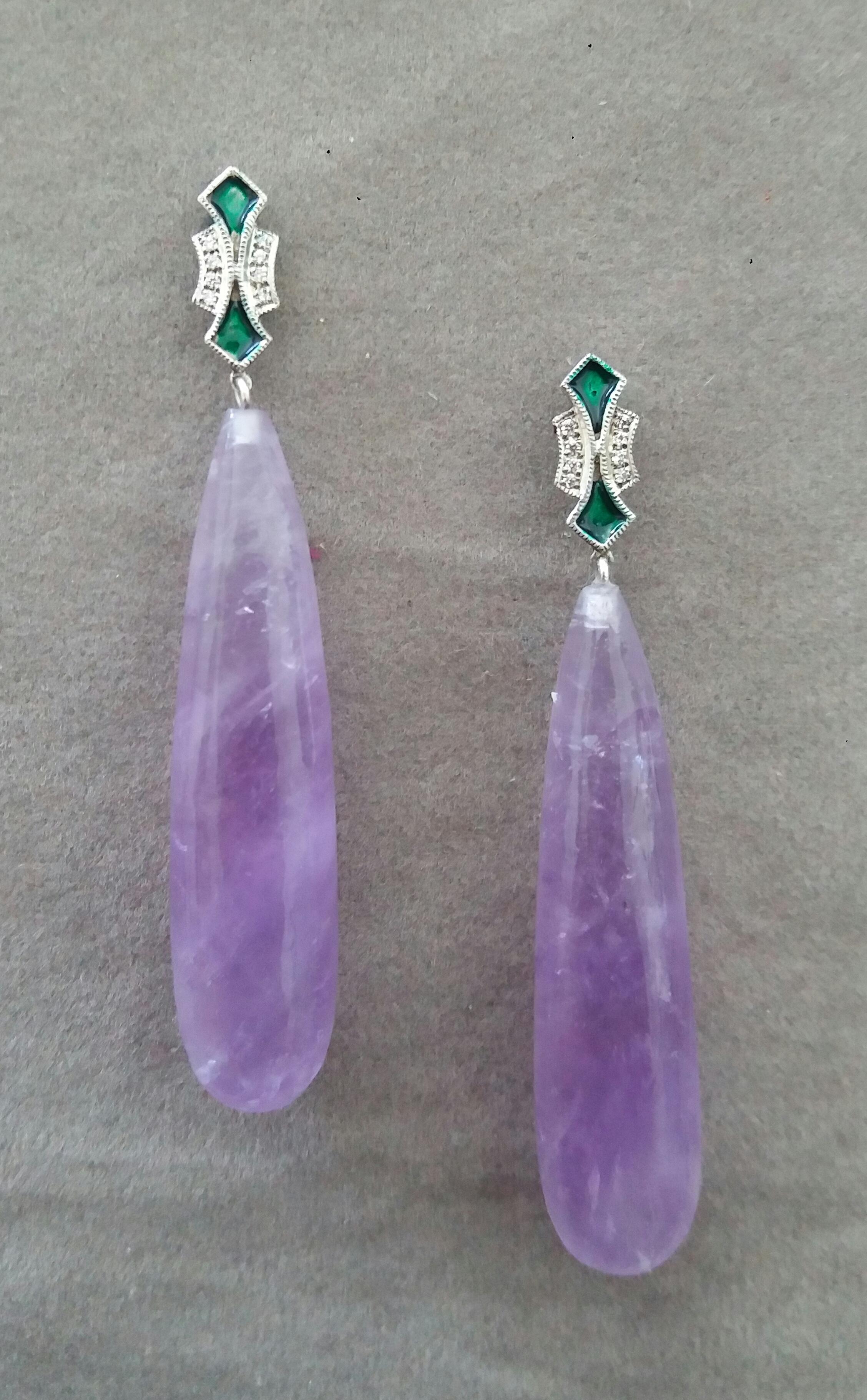 In these Art Deco Style handmade earrings 2 very good quality Natural Amethyst plain drops measuring 10 x  45 mm. are suspended from 2 white 14 kt gold tops  with 16 full cut round diamonds and Green Enamels.

In 1978 our workshop started in Italy