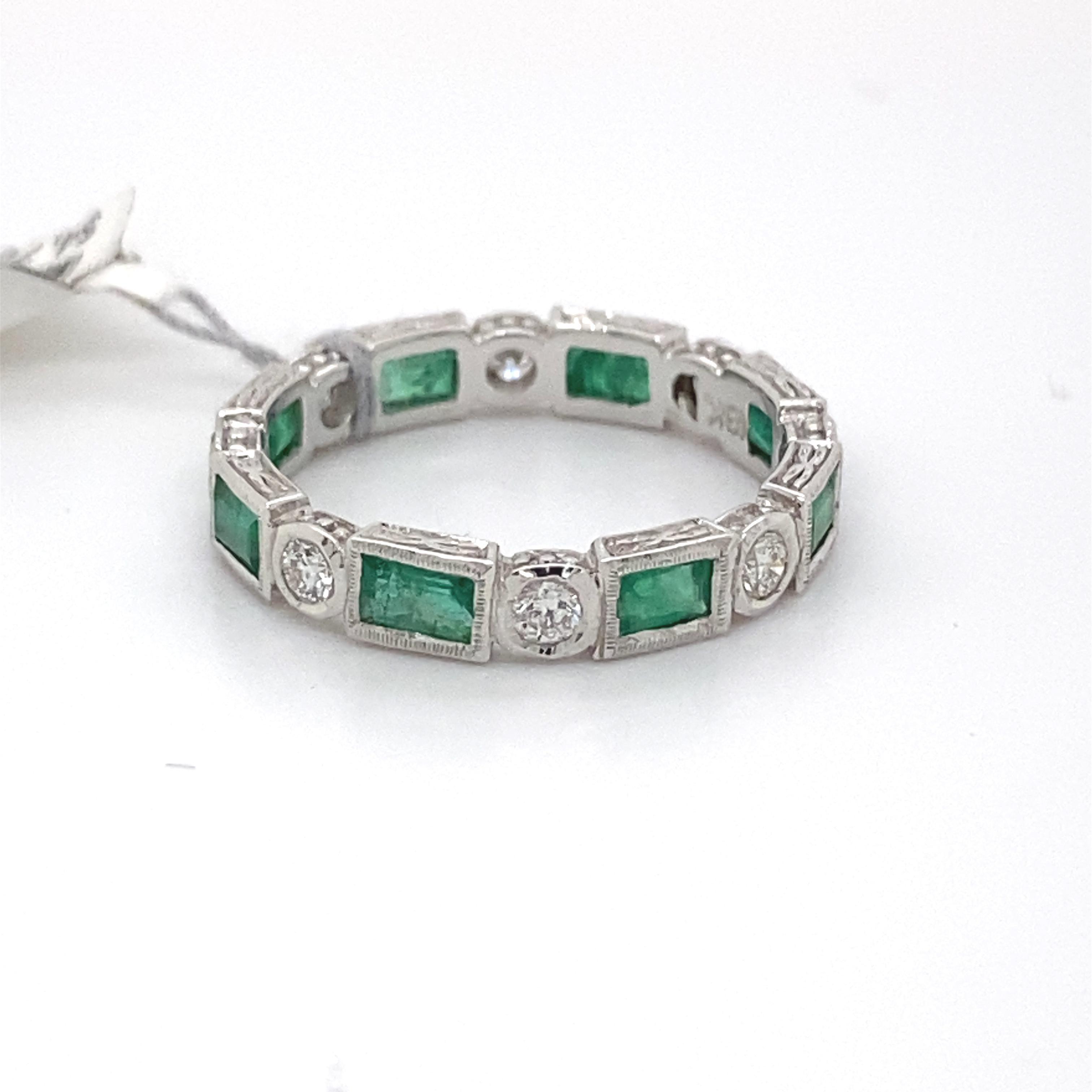 Art Deco style alternating emeralds and diamond eternity ring, with milgrain and filigree work.
8 baguette rubies, 1.05 carats. 8 round brilliant diamonds, 0.37 carats. Approximately G/H color and SI clarity. Bezel set in 18k white gold, size 6.5.