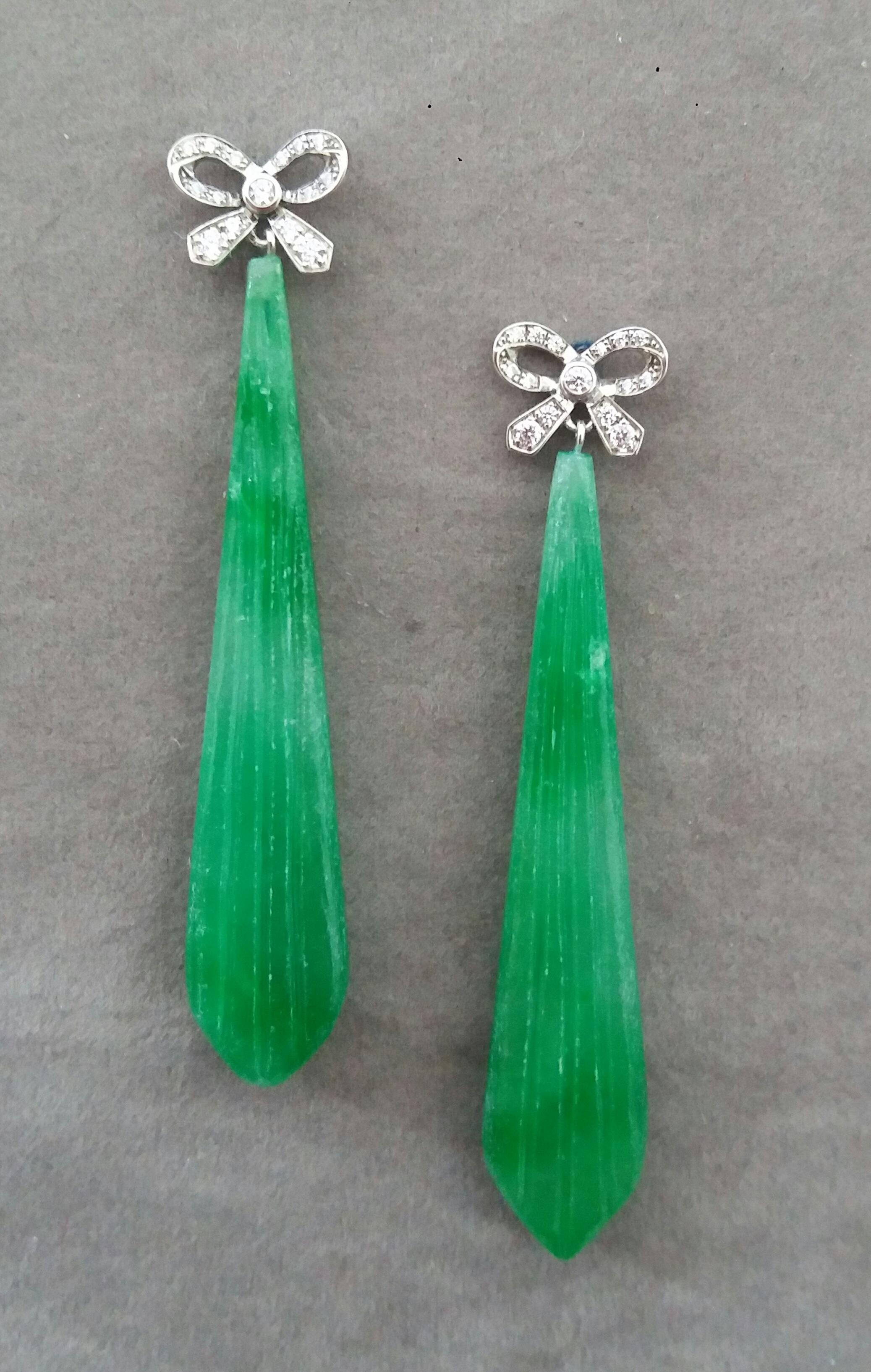 In these classic Art Deco Style earrings the tops are 2 White Gold and Diamonds  Bows, 28 round full cut diamonds and 1 pair ,in the lower parts we have 2 elongated Engraved Jade Drops measuring 13 x 62 mm. 

In 1978 our workshop started in Italy to