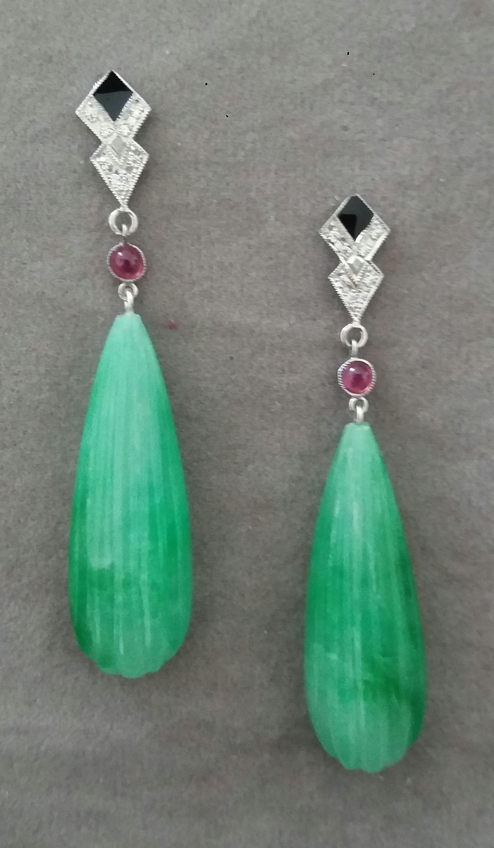In these classic Art Deco Style earrings the tops are 2 parts  in 14 kt.white gold, 16 round full cut diamonds,small round Ruby cabs and black enamel ,in the lower parts we have 2 Engraved Burma Jade  flat drops measuring 12 x 36 mm
In 1978 our