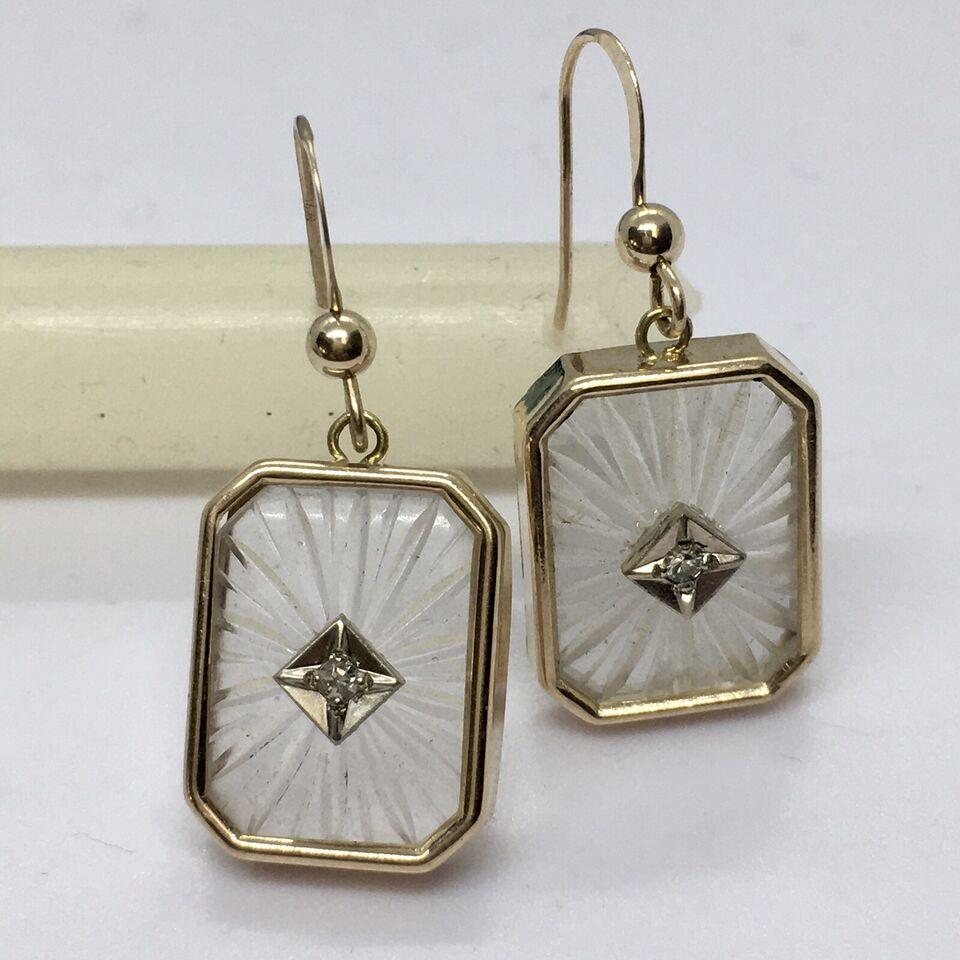 Art Deco Style 14k Yellow Gold Camphor Glass Diamond Earrings

Weighting 5.1 Gram
14K gold
Dimensions 17mm by 13 mm
Hangs about one inch
Two single cut diamonds weighting .03 Carat in total
