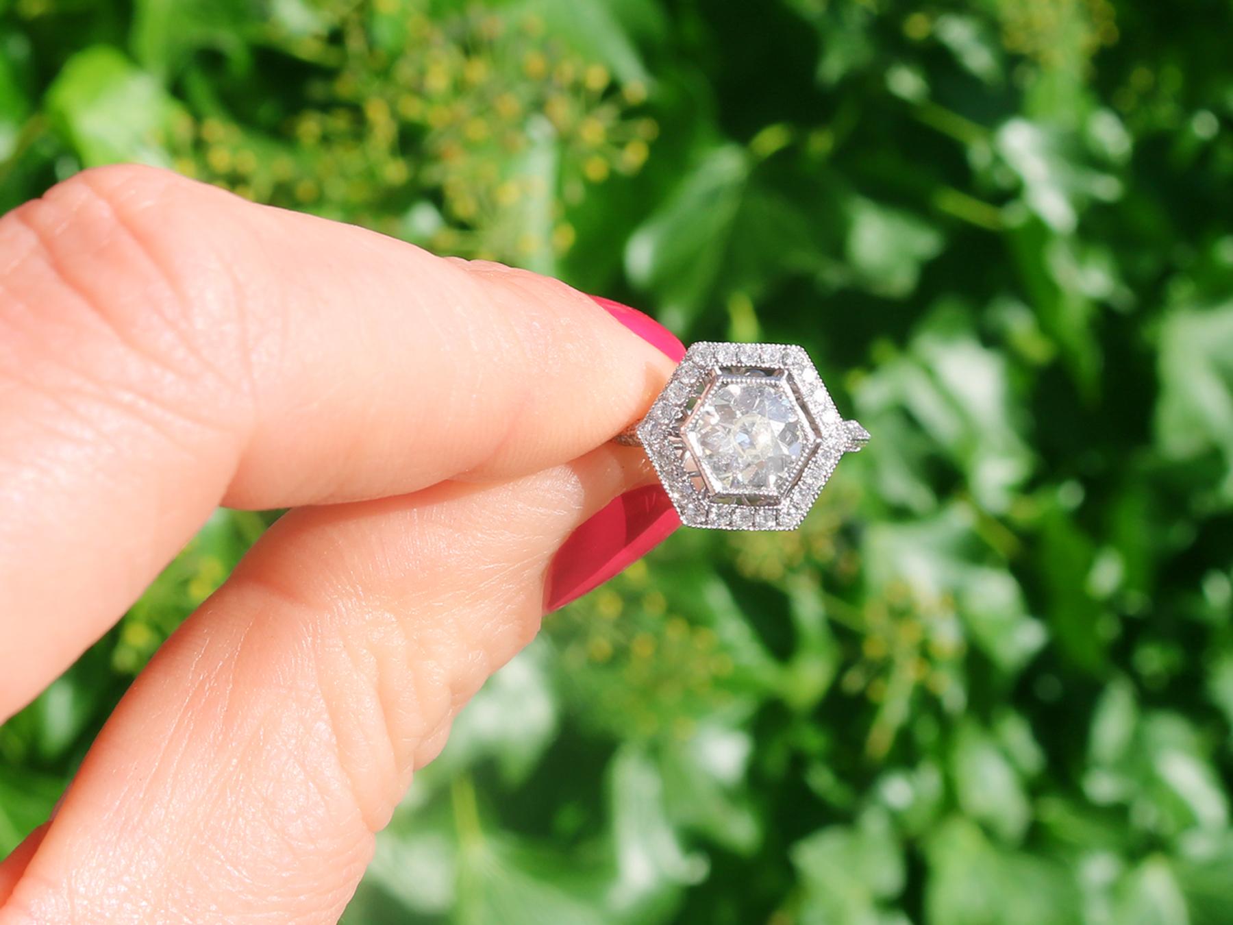 A stunning, fine and impressive antique 1.57 carat diamond and contemporary platinum engagement ring; part of our diverse diamond jewelry and estate jewelry collections.

This stunning, fine and impressive halo diamond engagement ring has been