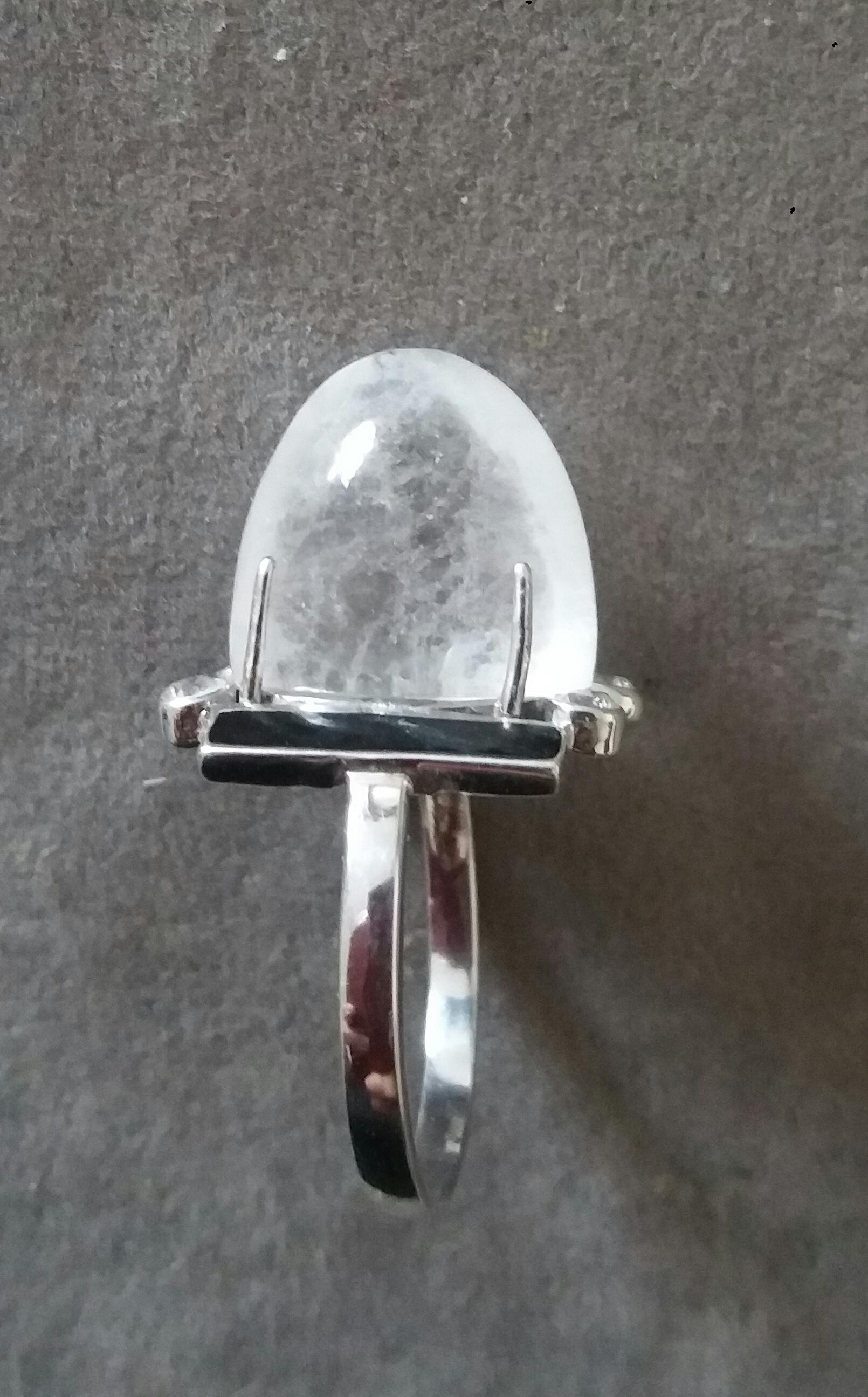 Classic Art Deco Style 14 Kt  white gold ring with a 18 Carat  Natural Quartz Sugar Loaf Shape Cabochon measuring 12x15x14 mm. surrounded by 4 full cut diamonds and 2 Black Enamel bars at the sides.

In 1978 our workshop started in Italy to make