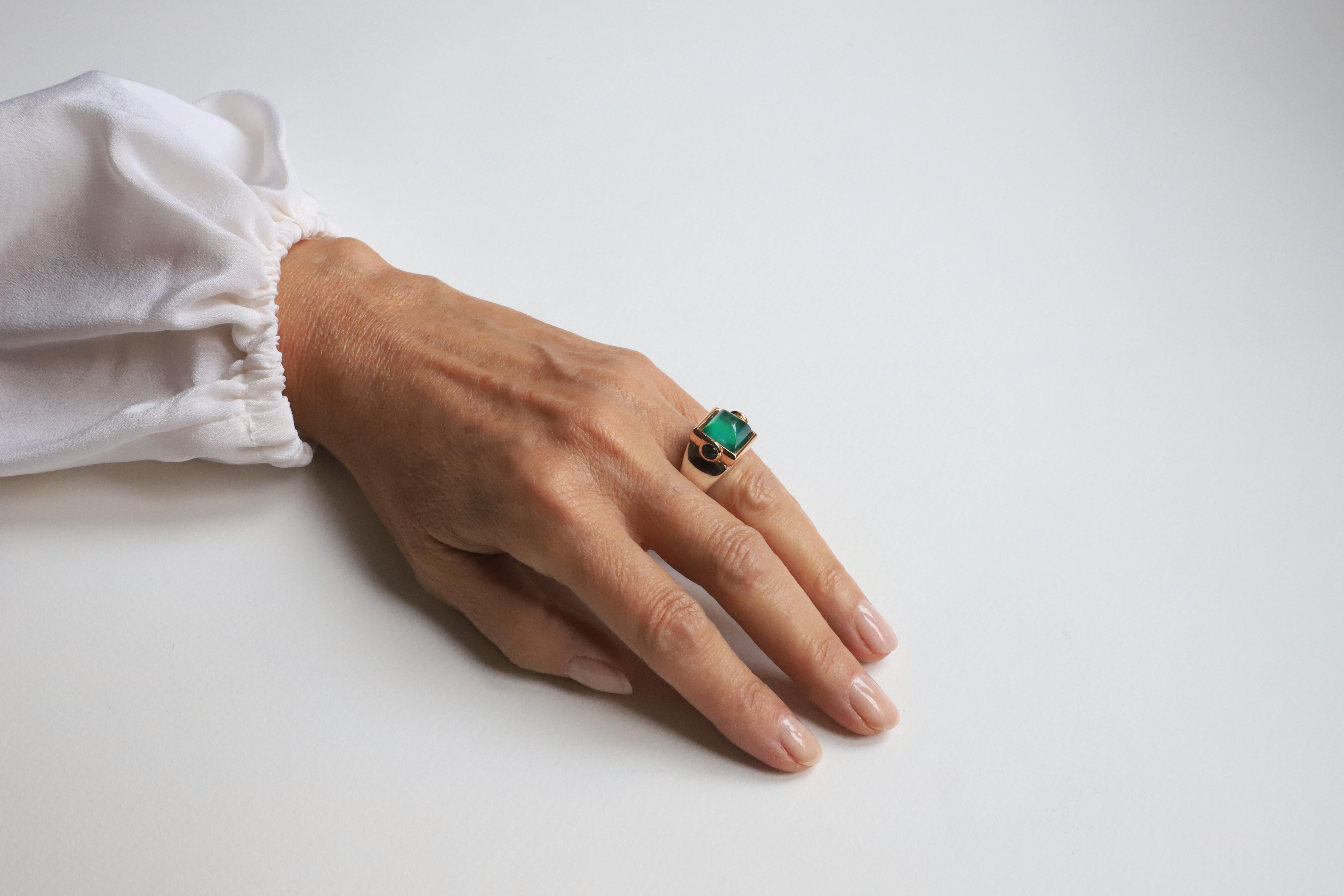 Indulge in the timeless allure of the Rossella Ugolini Design Collection - an extraordinary Art Deco style Ring meticulously handcrafted in 18 karat Yellow and White gold. With its captivating green Agate and rock crystal sugar loaf cabochon,