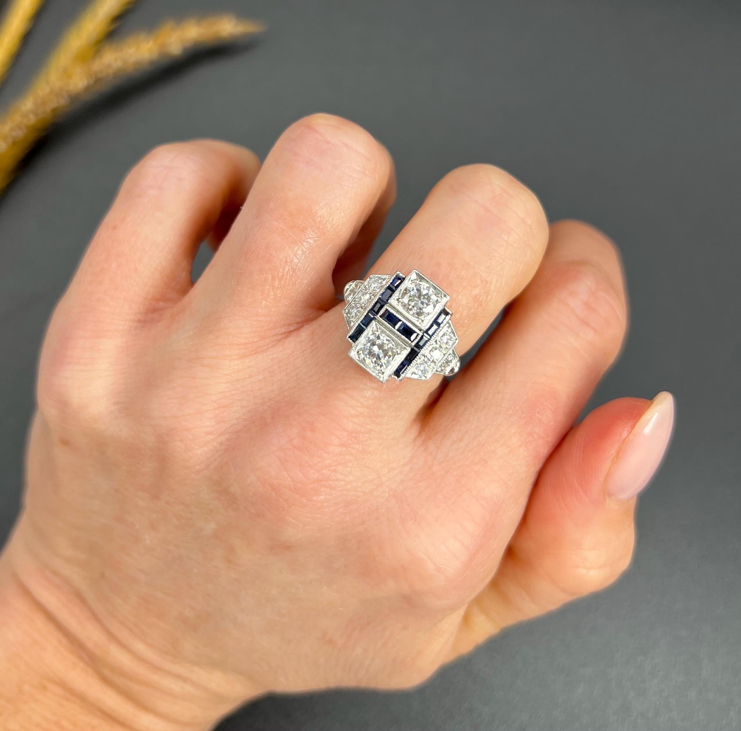 Deco Style Sapphire & Diamond Ring

18ct White Gold

Circa 2000

Embrace the elegance of the 1920s with this stunning 18ct white gold Art Deco-style ring. At its centre, a striking geometric plaque showcases two round brilliant cut diamonds,