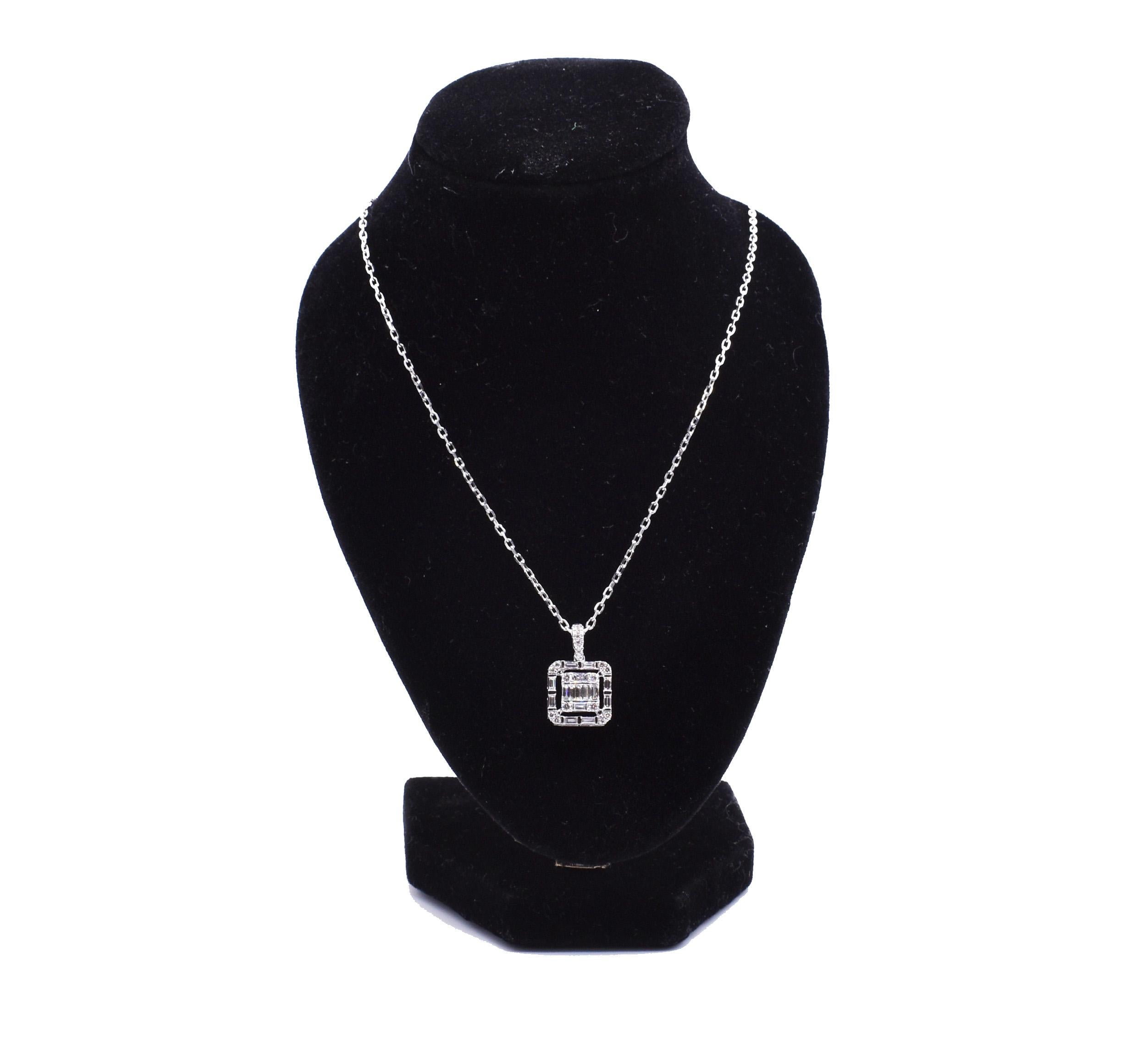 A splendid 18k white gold diamond necklace, featuring a series of baguette and round cut diamonds forming an art deco style pendant. 18 round cut diamonds = 0.20ct 14 baguette cut diamonds = 0.45ct. F/G colour VS clarity. Total diamond weight =