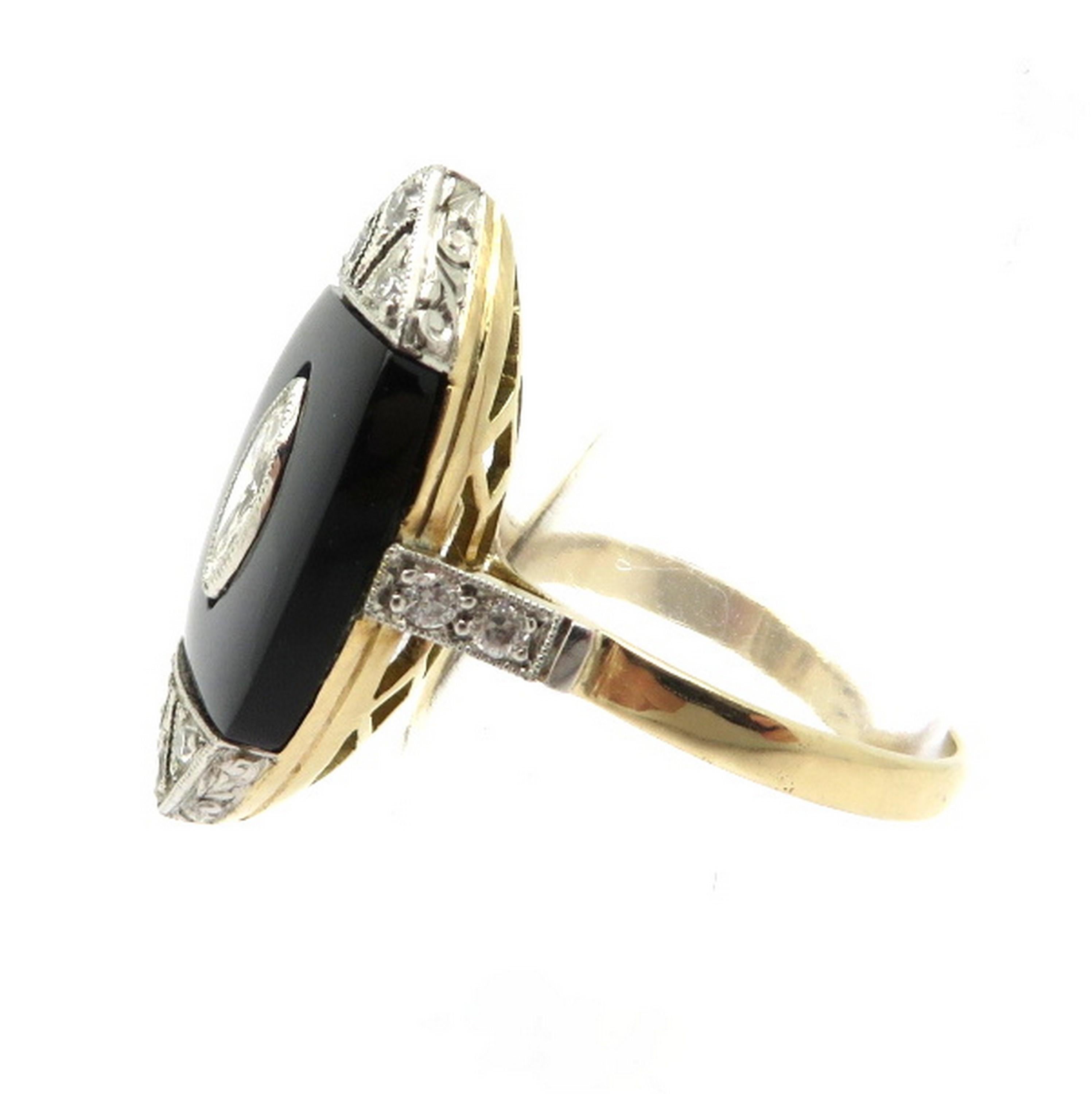 Estate Art Deco style 18K yellow gold and platinum black onyx and diamond navette ring. Showcasing one navette shaped fine quality black onyx. Accented with one bezel set marquise brilliant cut diamond, weighing approximately 0.26 carats. Displaying