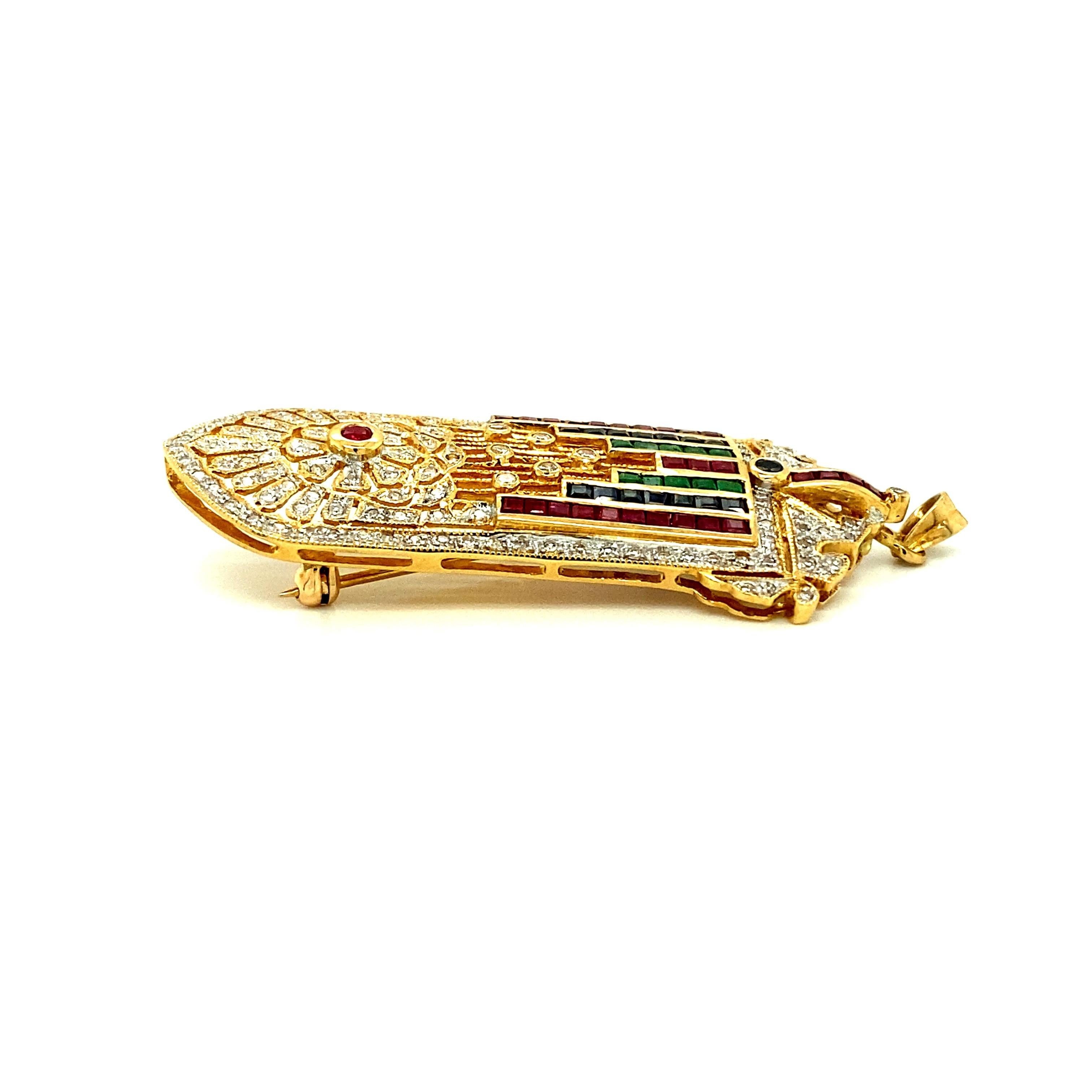 Offered here is an Art Deco Style Pendant made in 18kt Yellow Gold 
Weighted 13.60 gr. 
Adorned with 130 diamonds weighing approximately 1 ct & 53 gemstones, natural Sapphires, Ruby’s & Emeralds weighing about 2.20 ct total. 
Length: 2” x 3/4”