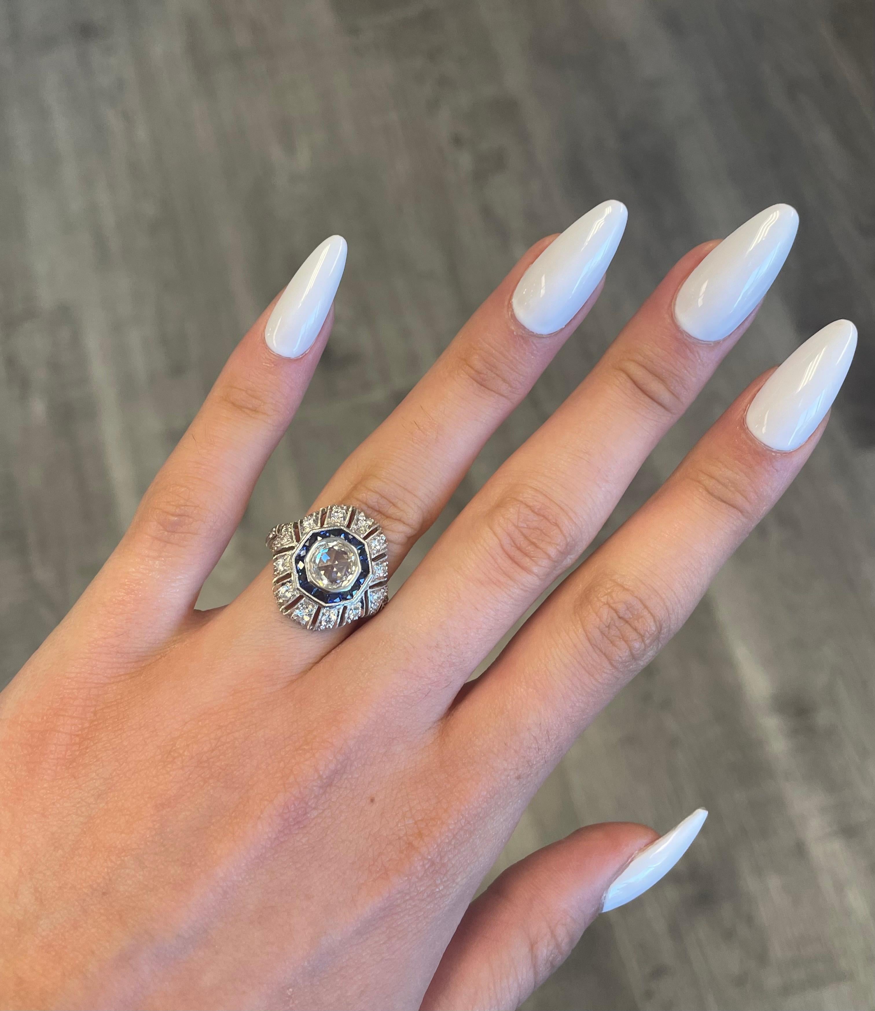 Art Deco inspired ring with a rose cut diamond and French cut sapphires. 
1.00ct center rose cut diamond. Complimented with 0.88ct of round diamonds and 1.00ct of French cut sapphires heat. 2.88ct total gemstone weight. 18k white gold with milgrain
