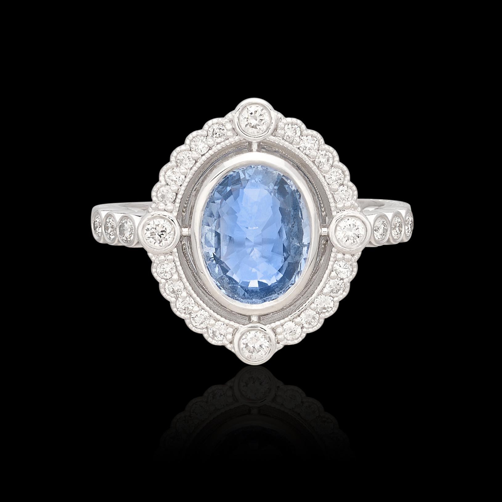 Timeless style and design highlights a unique violet-blue oval sapphire in this Art Deco inspired white gold ring. At the center is a 2.24 carat fine blue natural sapphire exhibiting a delicate blue color with gorgeous saturation that is only