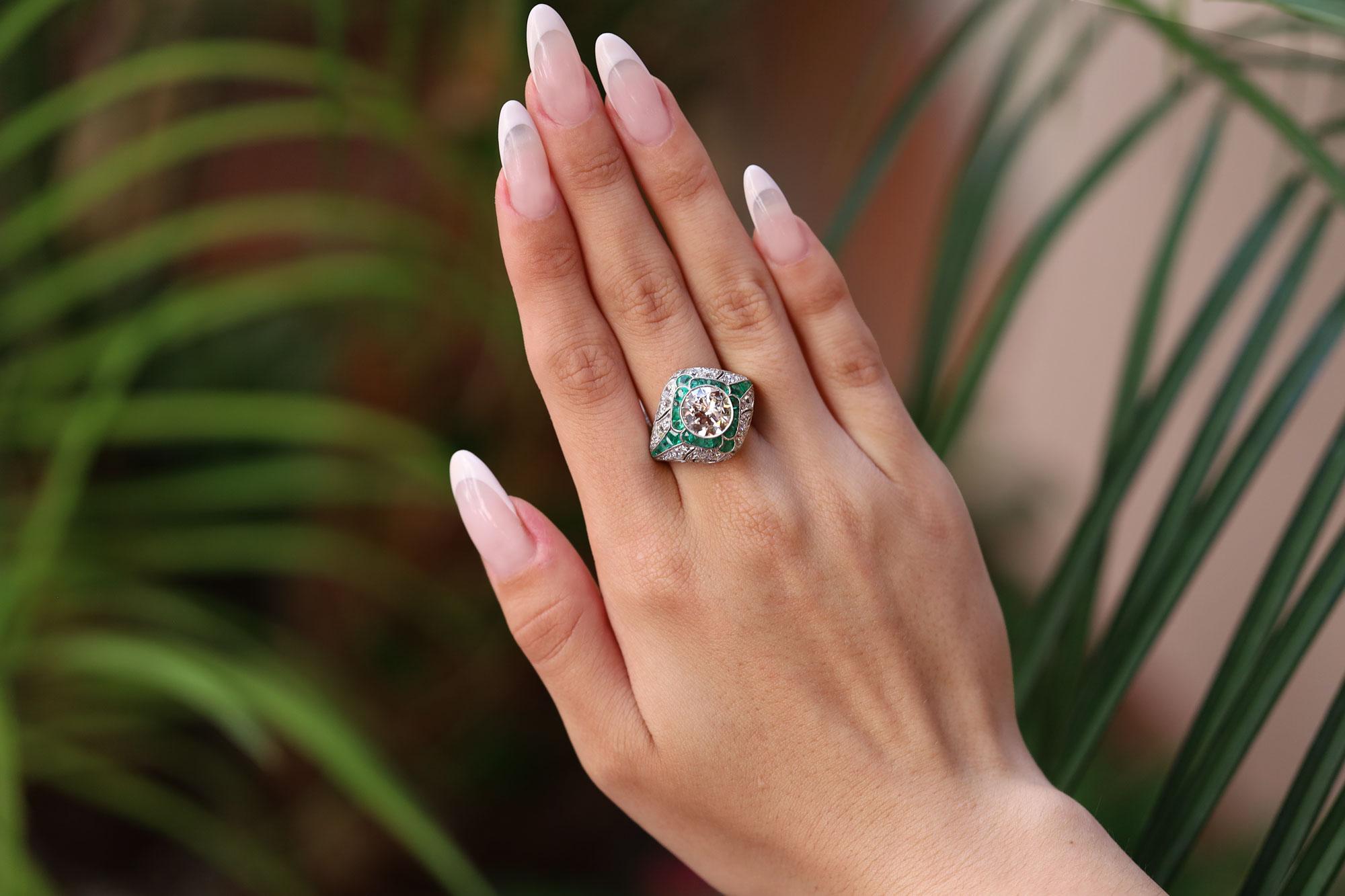 The spirit of the Art Deco era shines through with a 2.94 carat old European cut diamond commanding your attention. The large, chunky facets reflect even candlelight and dance before your eyes. The filigree details of this bombè, domed cocktail ring