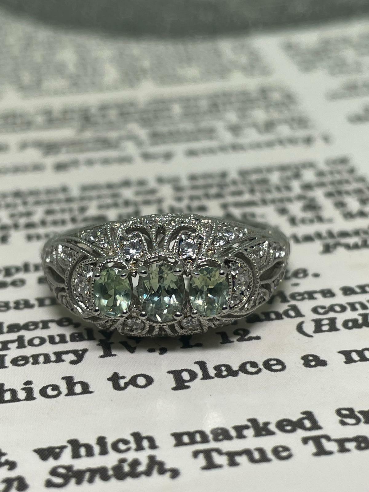 Of Art-Deco style,
this impressive vintage ring is meticulously crafted in 925 Sterling Silver, 
embellished with fine Swiss Cubic Zirconias (CZ's) 
within gorgeous pierced gallery setting, 
featuring openwork & floral motifs 

Centering 3 Natural