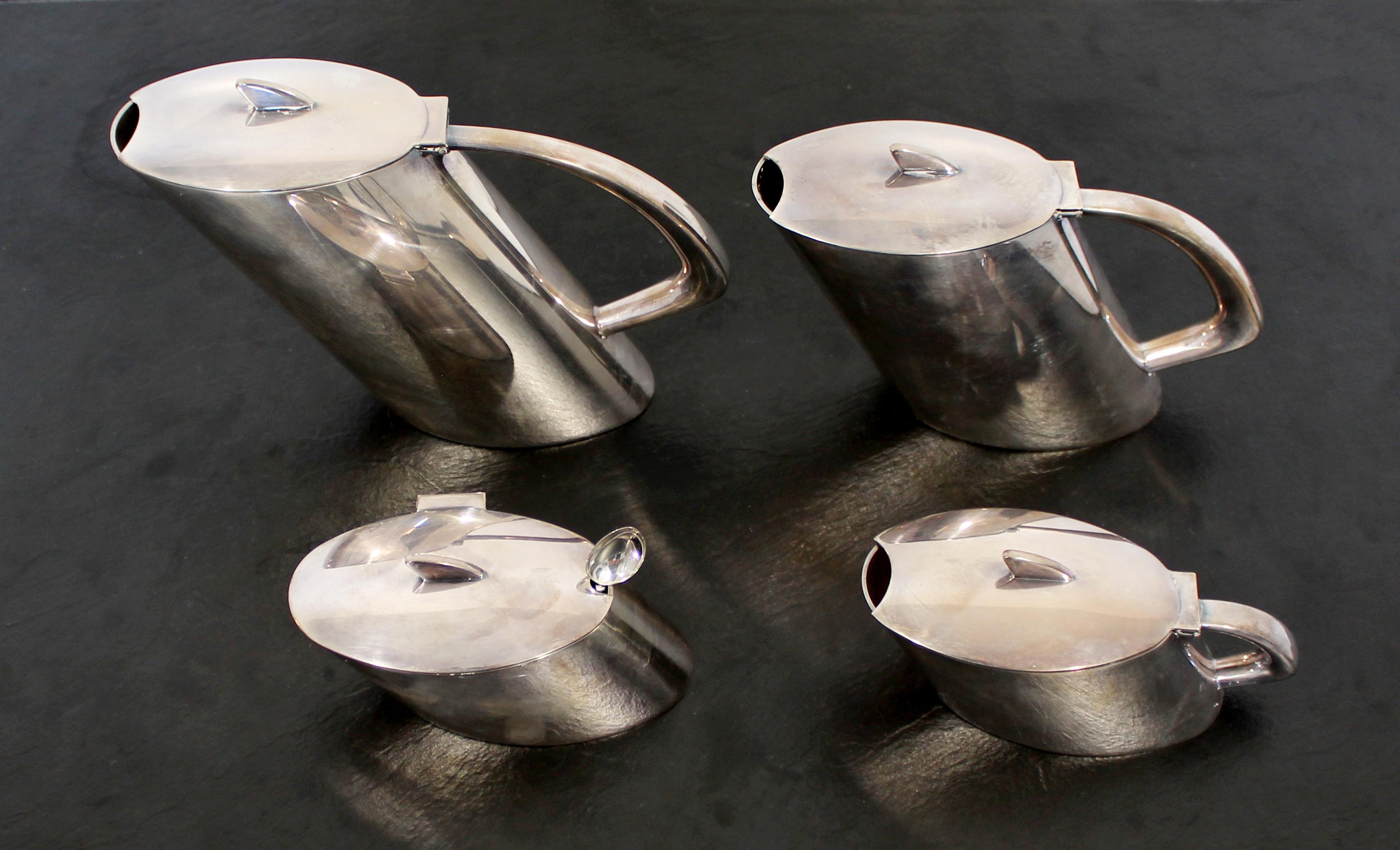 For your consideration is a sterling silver, four piece tea & coffee service, handmade by Christoph Widmann, in Germany, circa 1990. The unique shapes of the pieces give them the feel of a speeding train. Winner of Frankfurt Fair award at the time