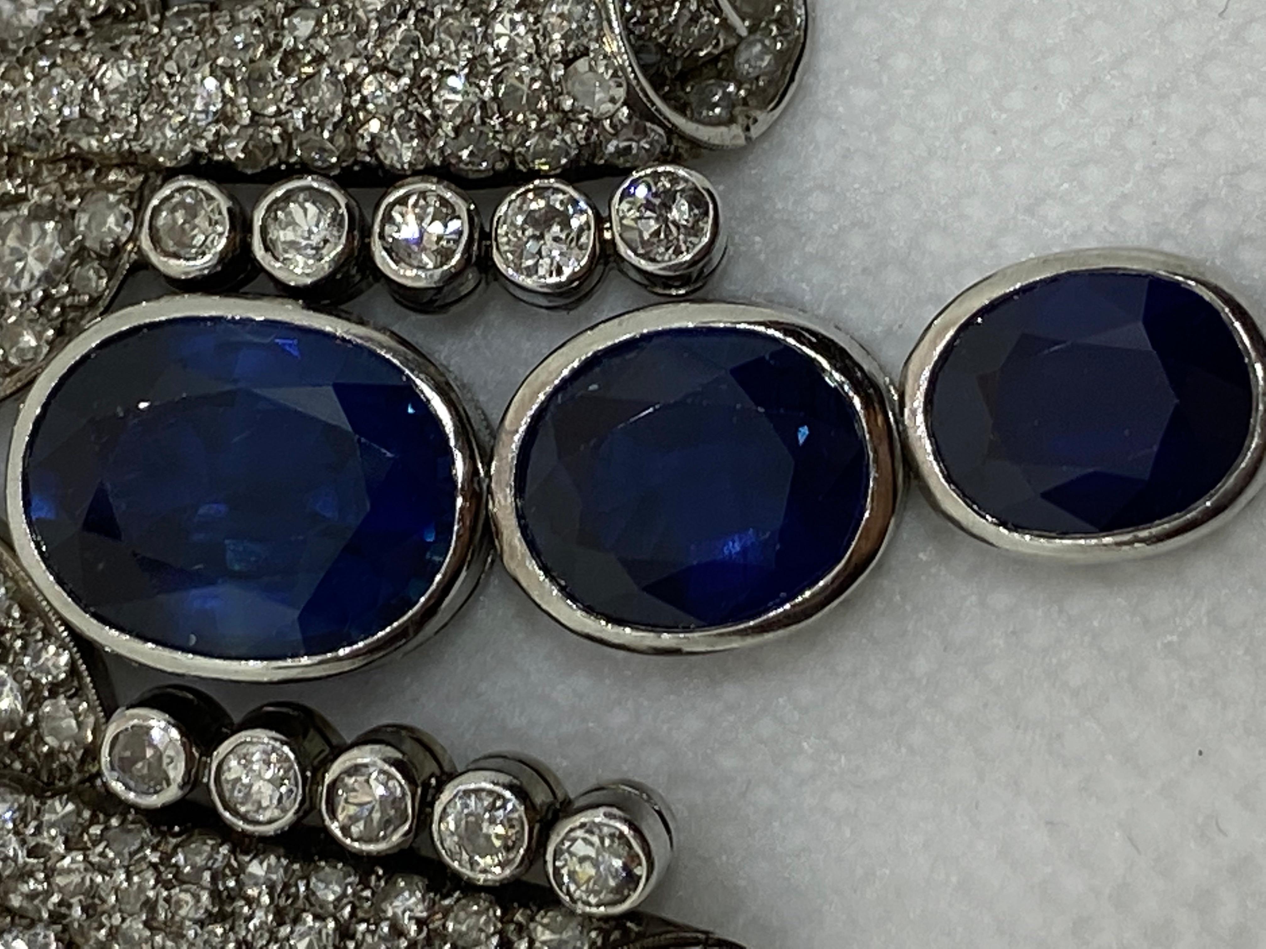 AGL-Certified Sapphire Necklace with Diamonds.
The front is set with three graduating oval sapphires (7.89, 5.01, and 3.64 ct). The biggest sapphire is AGL-certified. The gems are mounted in platinum. Diamonds are weighing approx. 29.77 ct.
The size
