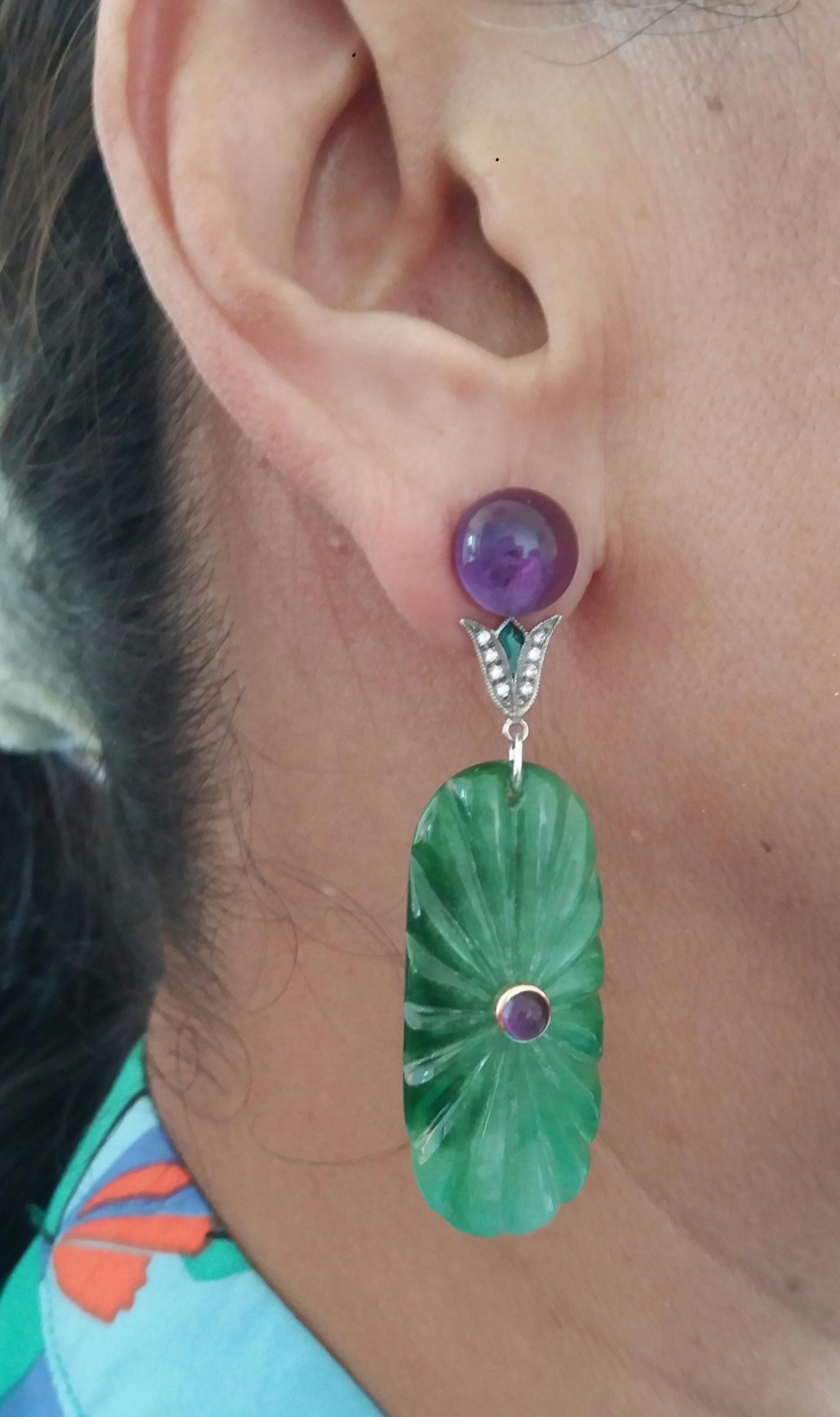 These unique earrings have 2 Amethyst round buttons of 10 mm in diameter on top,  supporting  2 elements in white gold 16 full cut diamonds and green enamel, to which finally are suspended  2 Engraved Jades in oval shape size 16 x 40 mm. with 2