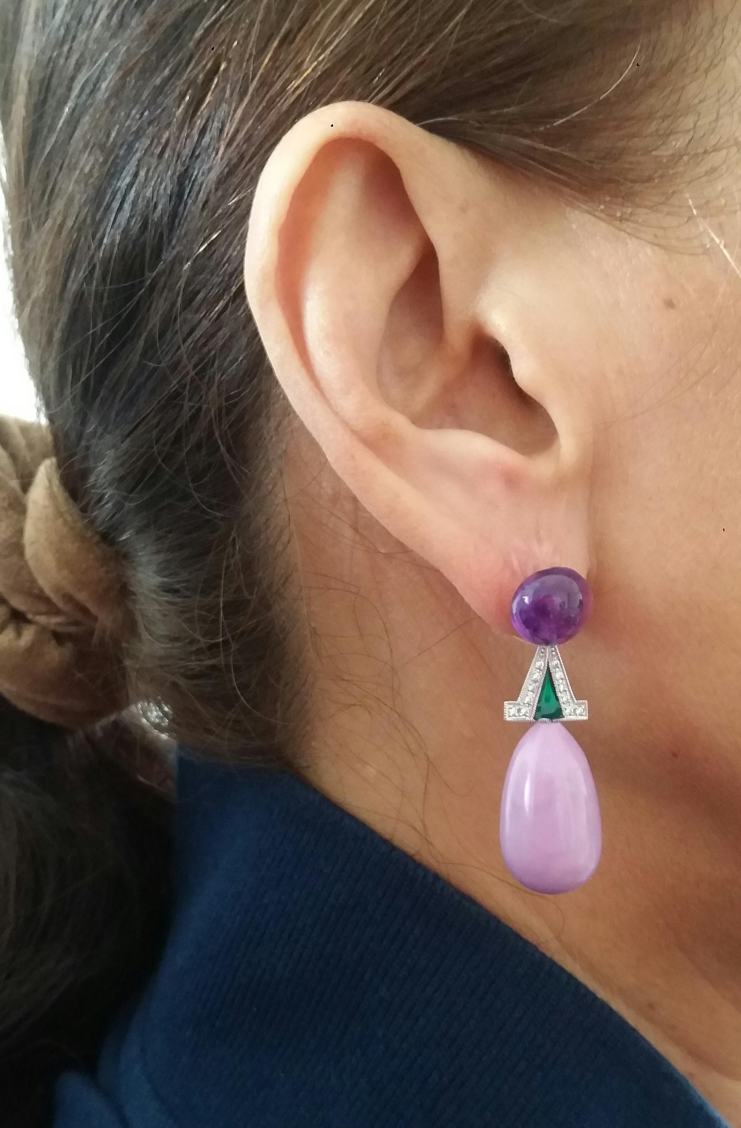 A pair of earrings with 2 Amethyst buttons diameter 10mm that support 2 elements in white gold, diamonds and green enamel, in the lower part we have 2 Phosphosiderite round drops 12x24 mm
In 1978 our workshop started in Italy to make simple-chic Art