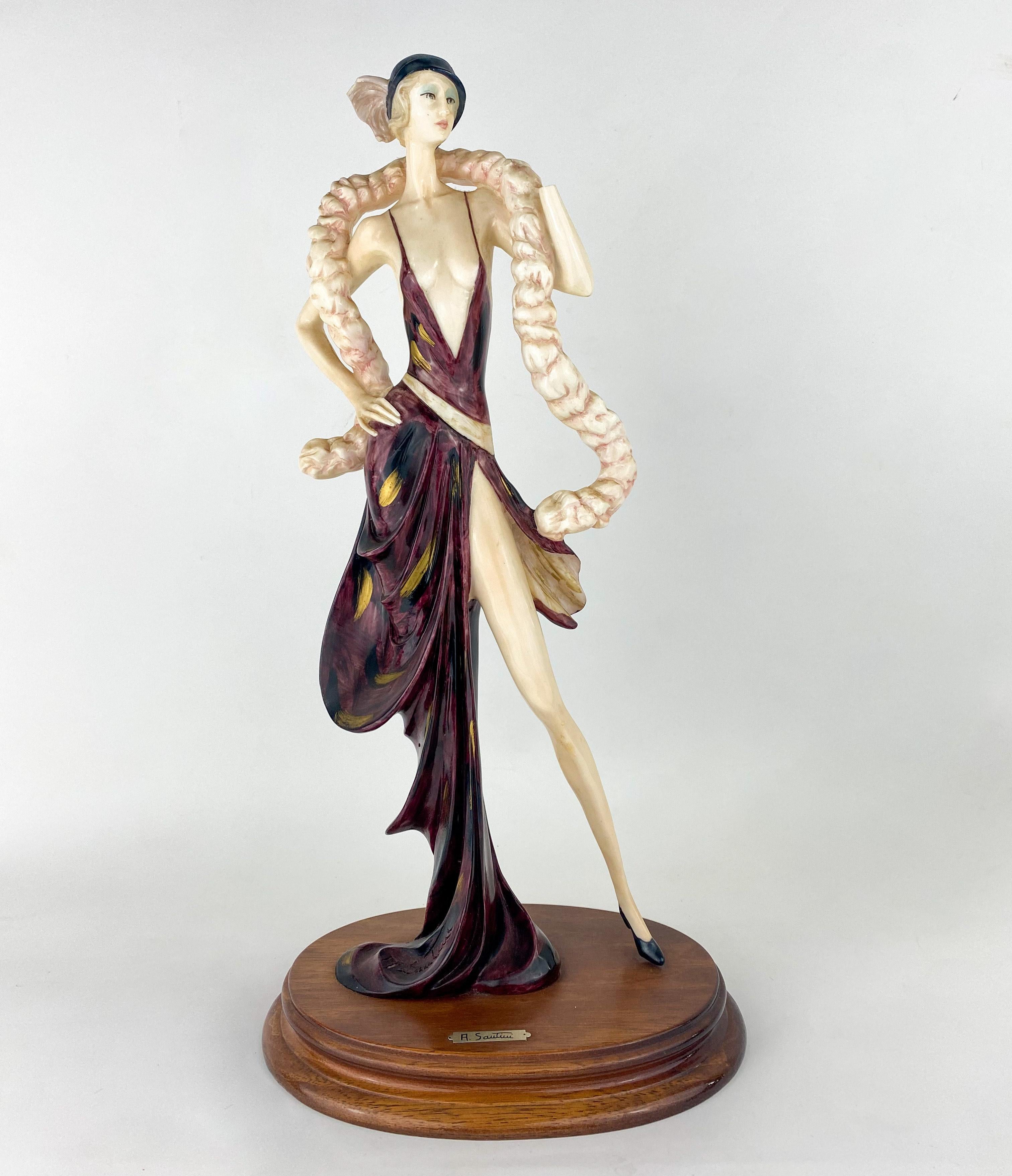 A beautiful sculpture reproduction by A. Santini after the original work of Amilcare Santini ( Italian , 1910 - 1975). The sculpture, made of Alabaster, represents an elegant lady with a long silhouette from the Art Deco era inn a festive outfit.