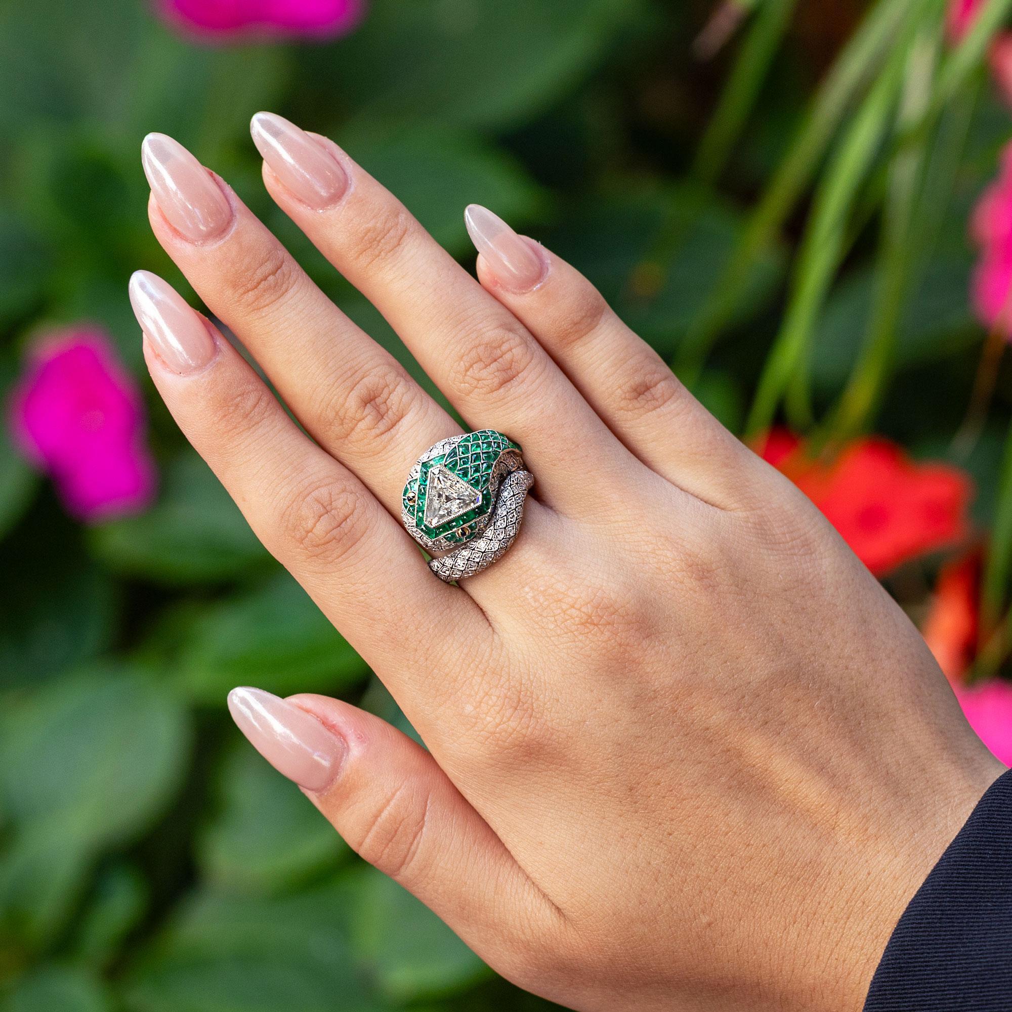Bask in the beauty of this gorgeous antique-inspired diamond snake ring. Crafted in a timeless Art Deco design, this luxurious piece presents a refined, lively air. The coveted, antique triangular step-cut diamond weighing 1.16 carats brings this