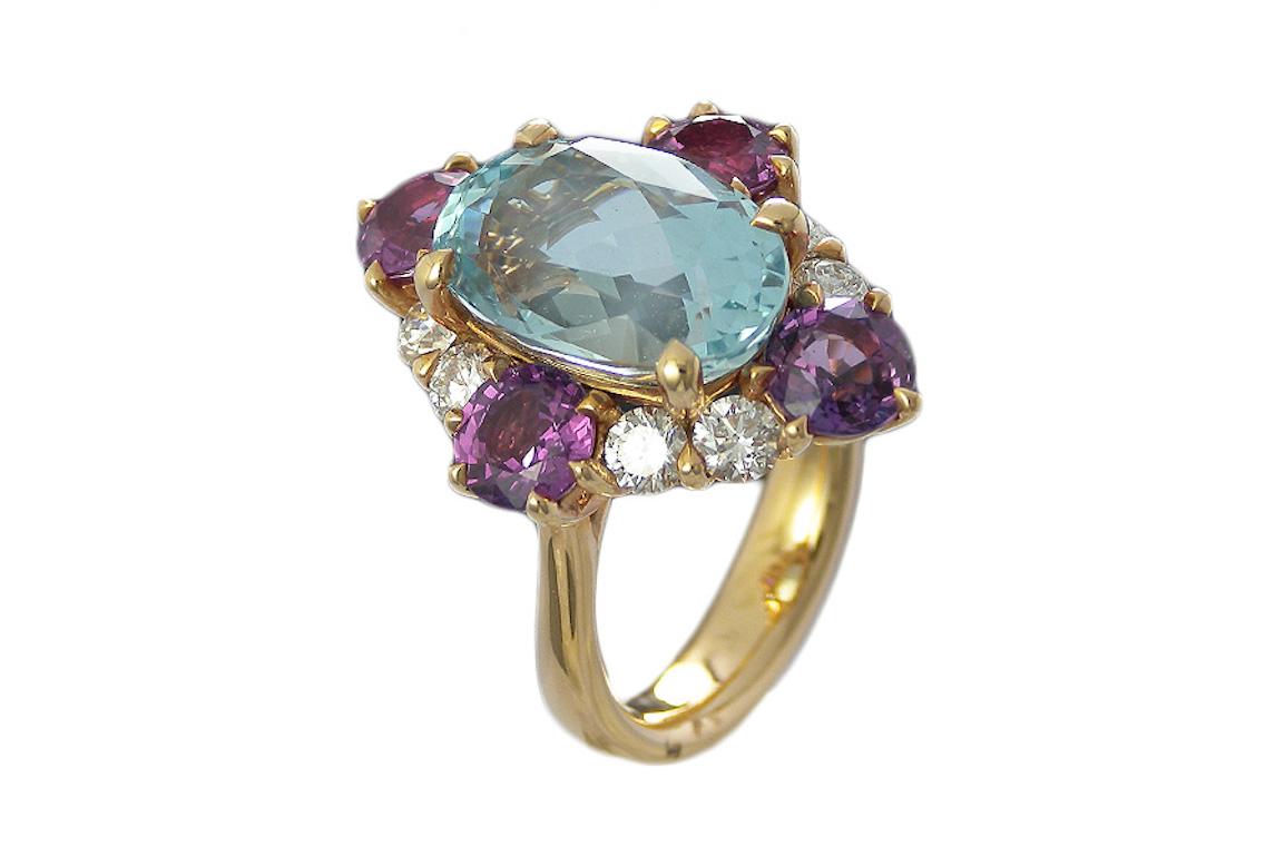 This  Art-deco looking, statement 5.88 carat oval cut Aquamarine  framed in a 4 claw and surrounded  by 3.10 carat Round Pink Sapphires and 0.91 carat Round Diamonds all prong set in 18 Karat Pink Gold. ​

Ring Details: ​

Aquamarine : 5.88 