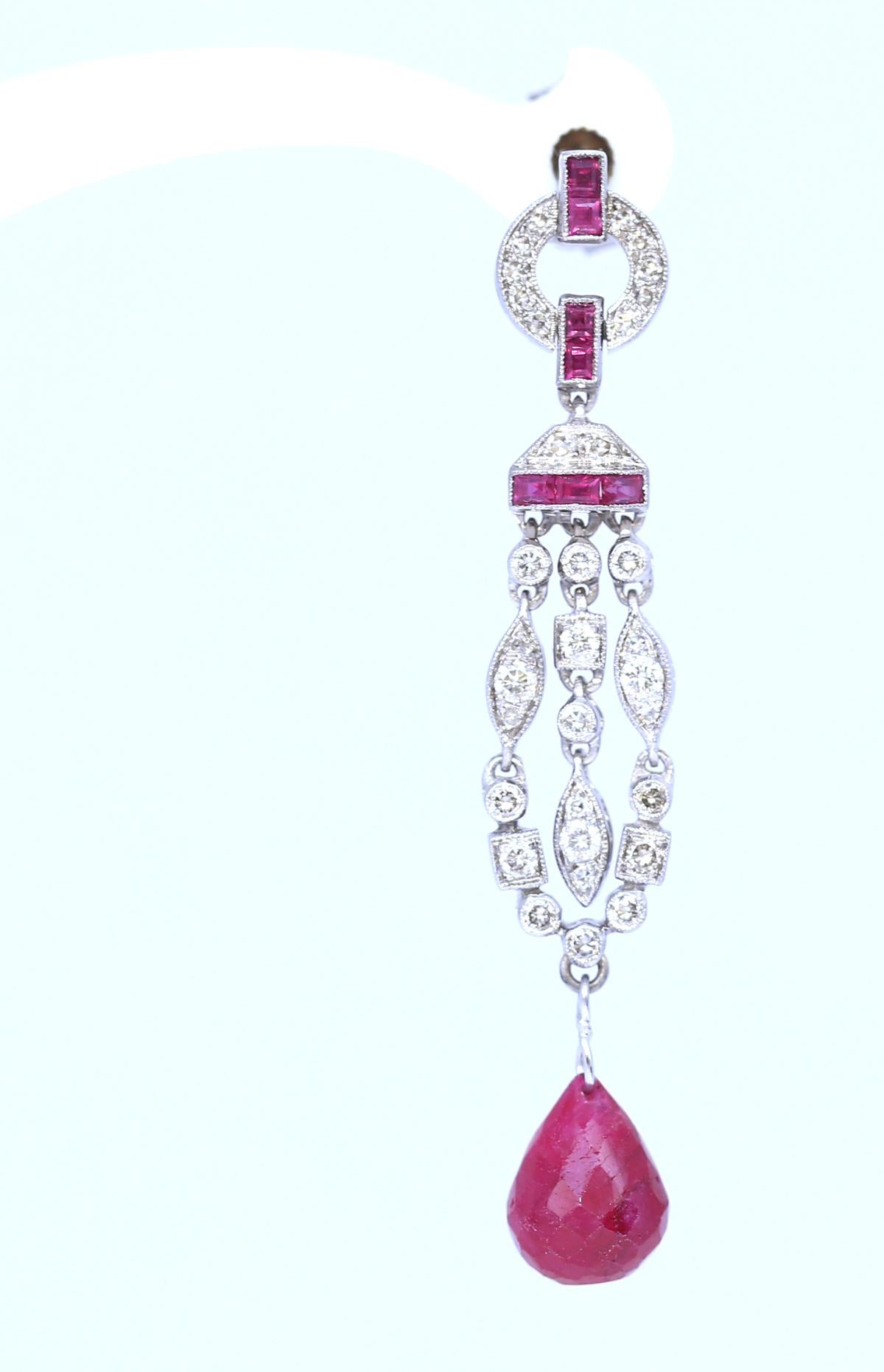 Art Deco Style Baguette Briolet Rubies Diamonds Earrings, Created around the 1970.

Perfectly matching the Art Deco style with different geometrical forms and shapes. Baguette Rubies in red lines, Briolet Rubies, almost droplet shape in the bottom.