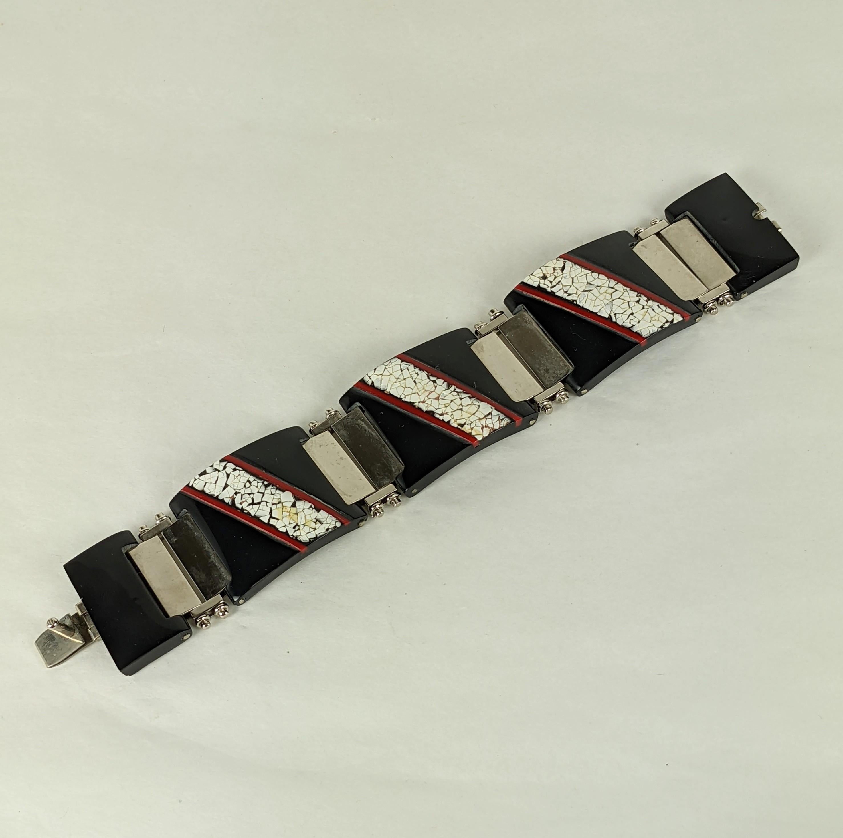 Attractive Art Deco Style Bakelite and Eggshell Lacquer Bracelet from the 1980's. Made in the Art Deco style this link bracelet is composed of black bakelite links inset with eggshell lacquer decoration and red bakelite striped insertions. Chrome