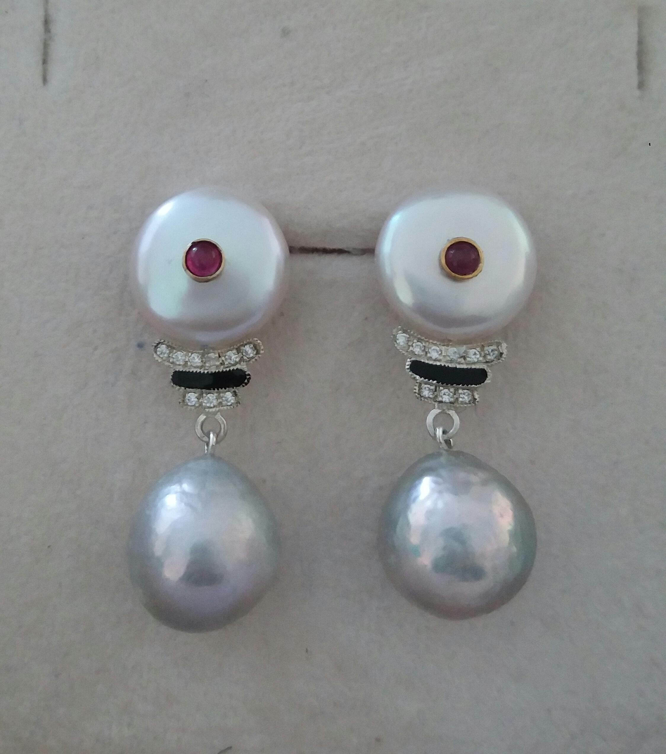 Classic Art Deco Style earrings with the top with 2 round flat Fresh Water pearls 14 mm in diameter with small round Ruby cabs in the center,middle parts are composed of 2 white gold elements , 18 full cut  round diamonds and black enamels,2 natural