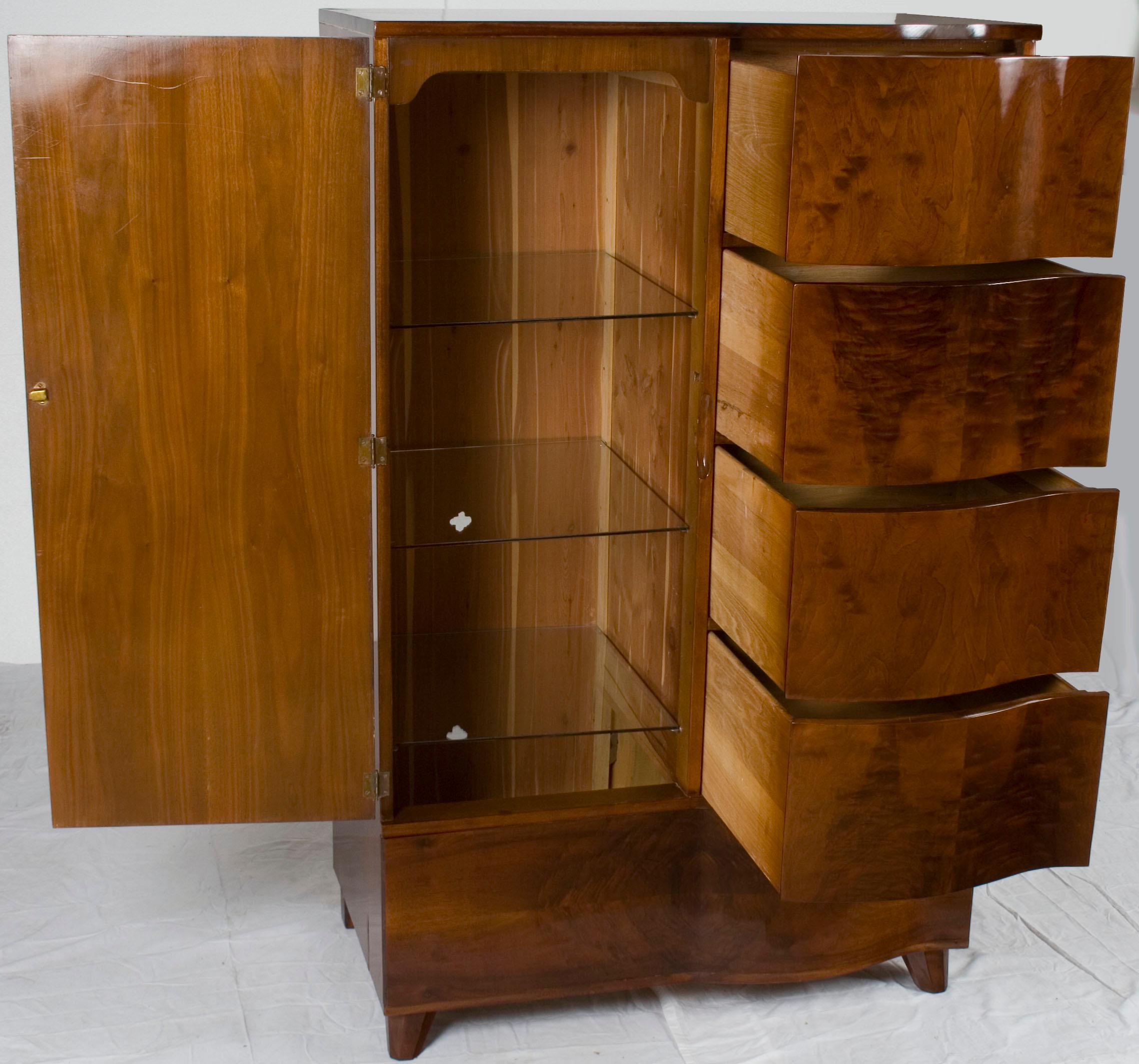 This elegant Art Deco wardrobe was made sometime around the year 1960. Today it remains in great overall condition with plenty of space and functionality.

The selection of mahogany in this armoire is quite rich, with a luxurious complexion and a