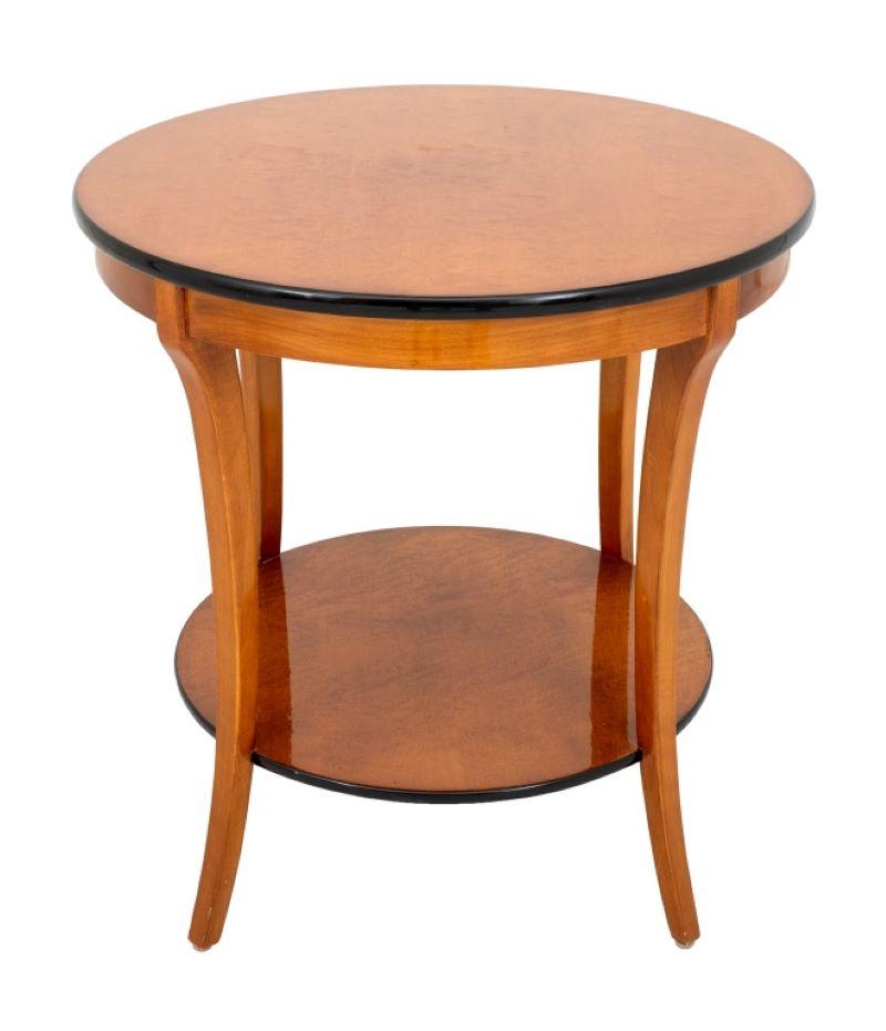 Art Deco Style Birdseye Maple Two-Tier Round Side Table, with black lacquered trim on four tapered legs. 26.25