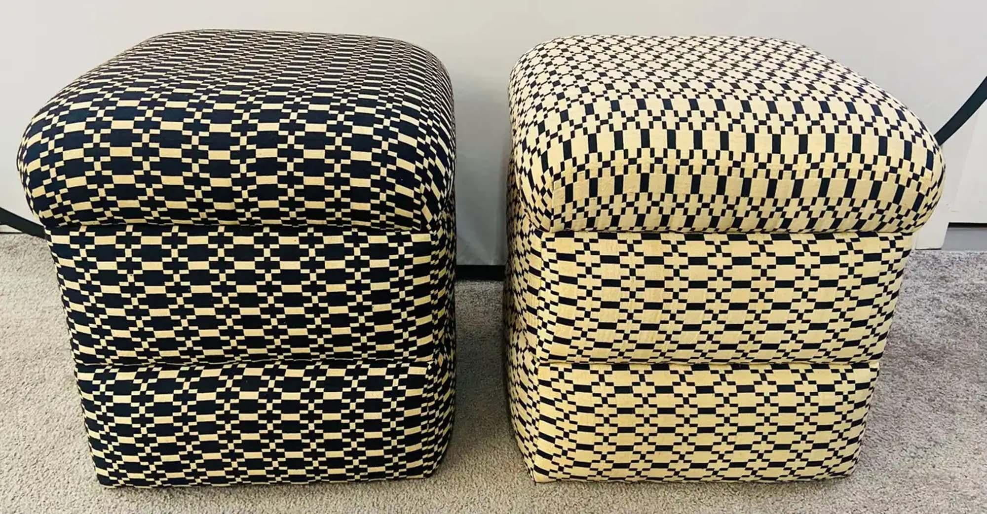 An exquisite pair of Art Deco style cube ottomans or stools. The compatible pair of ottomans are beautifully upholstered and are hand tufted. In addition to featuring stylish geometrical motif in black and beige/ off white, the cube shape creates a