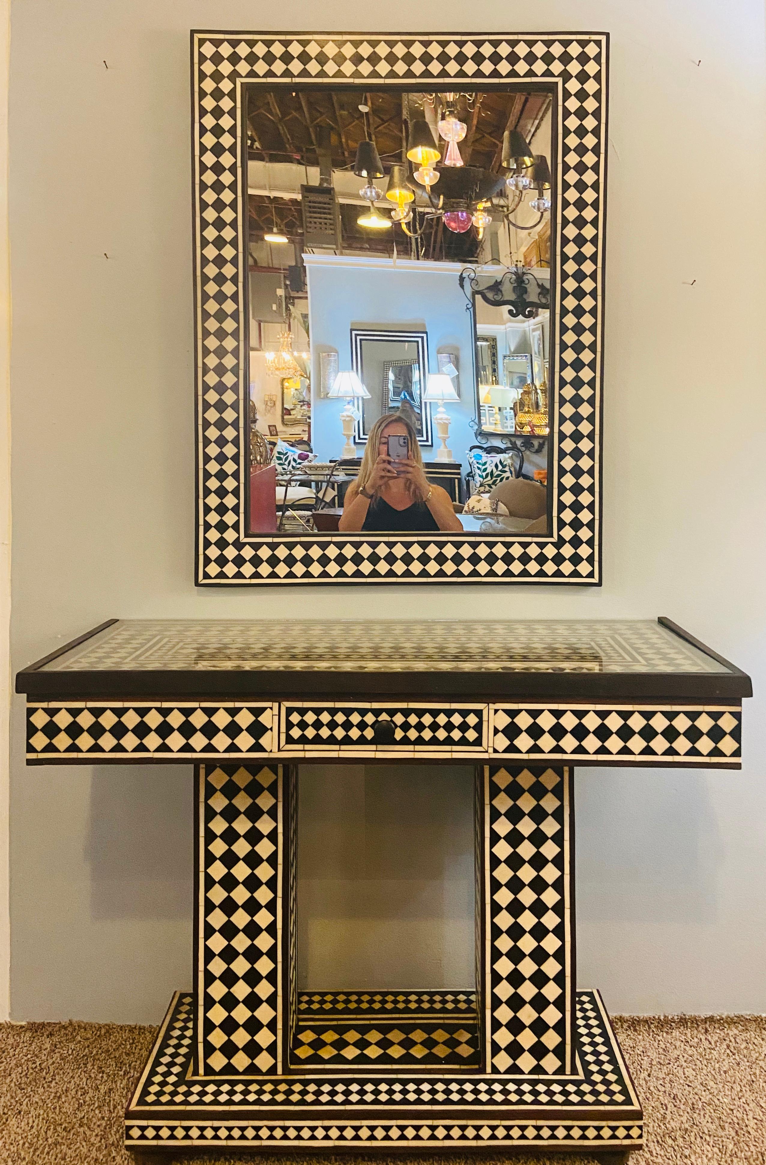 Art Deco style black and white console table and mirror in diamond pattern
A beautiful Art Deco style black and white console table and matching mirror. The pair is made of resin and shows wood inlay in brown. The retro modern geometric midcentury