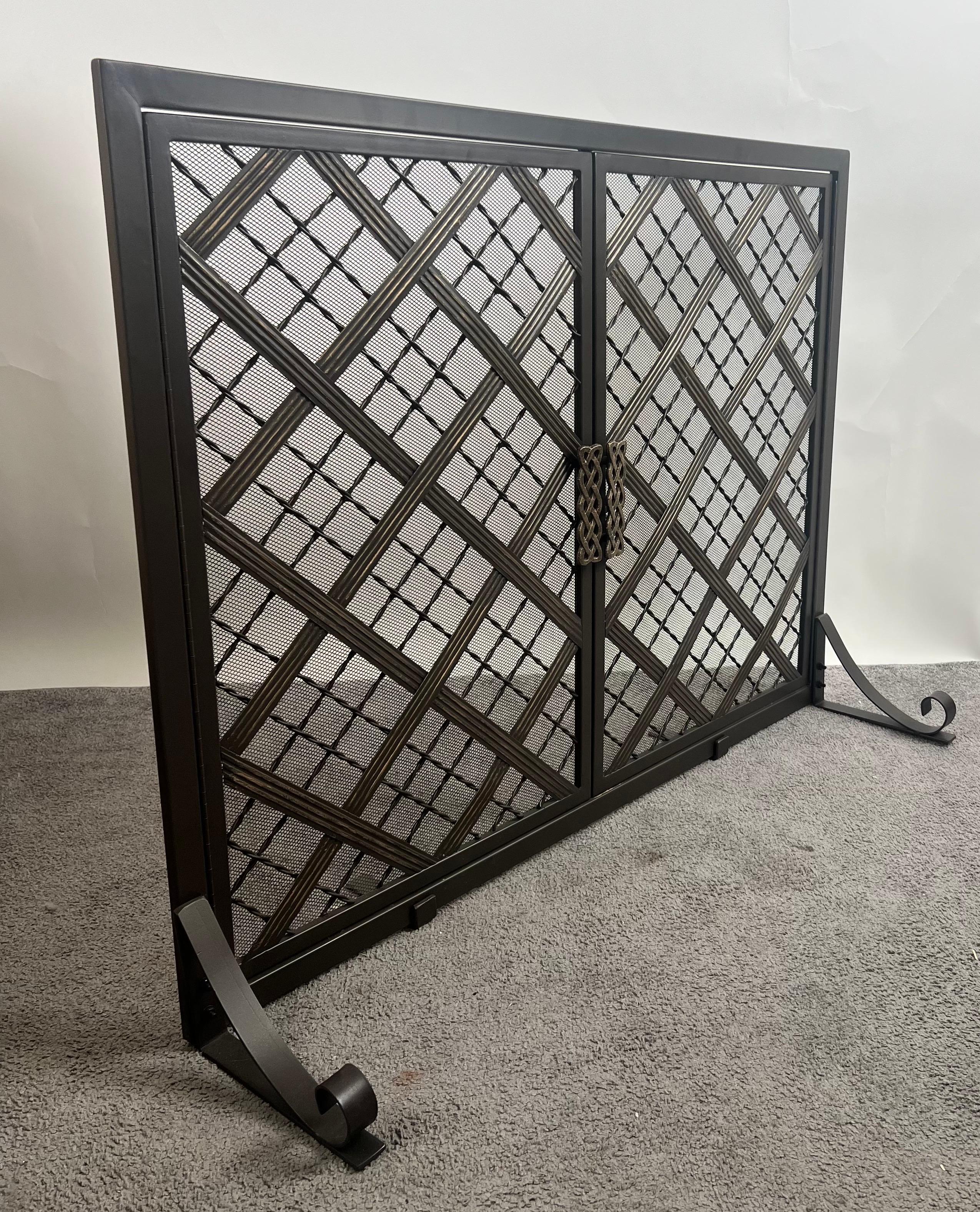 
Art Deco Style Black & Bronzed Metal Two-Door & Diamond Design Fireplace Screen:
 
The Art Deco style fireplace screen features a sleek black metal frame, enclosing a dramatic lattice of overlapping diagonal and diamond grids finished in a bronzed