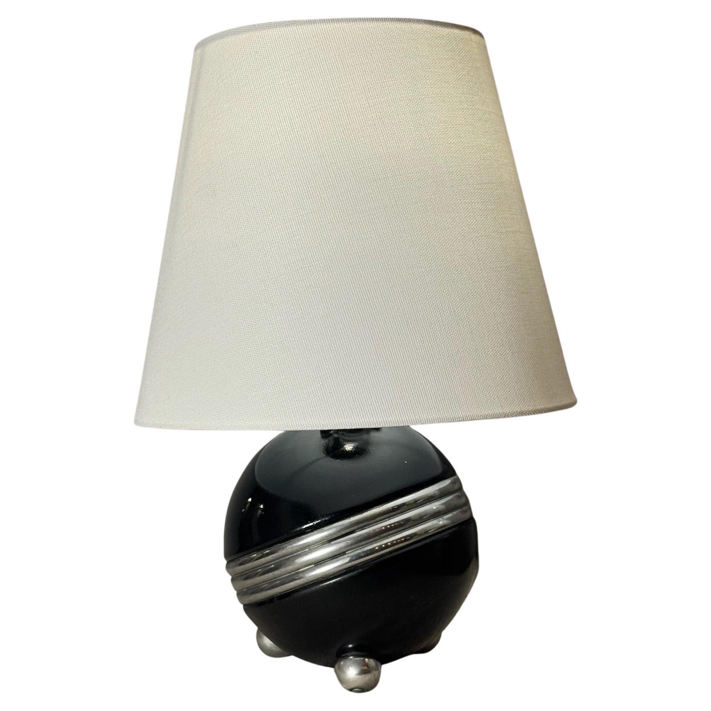Art Deco Style Black Ceramic Orb Table Lamp with Chrome Banding and Tripod Feet For Sale