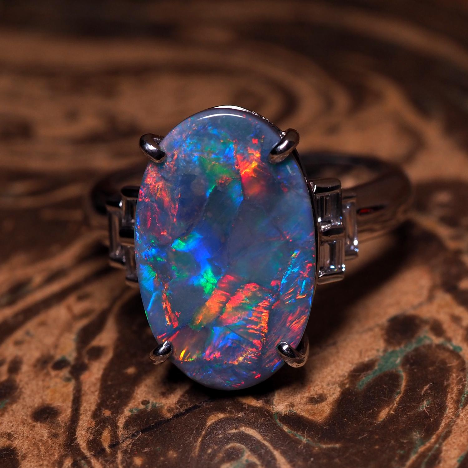 Rare Custom Made Platinum Black Opal & Diamond Ring
Allow this stunning brightly polished platinum black opal and diamond ring to capture your attention, custom made with keen attention to detail. Baguette cut diamonds are placed on each side of the