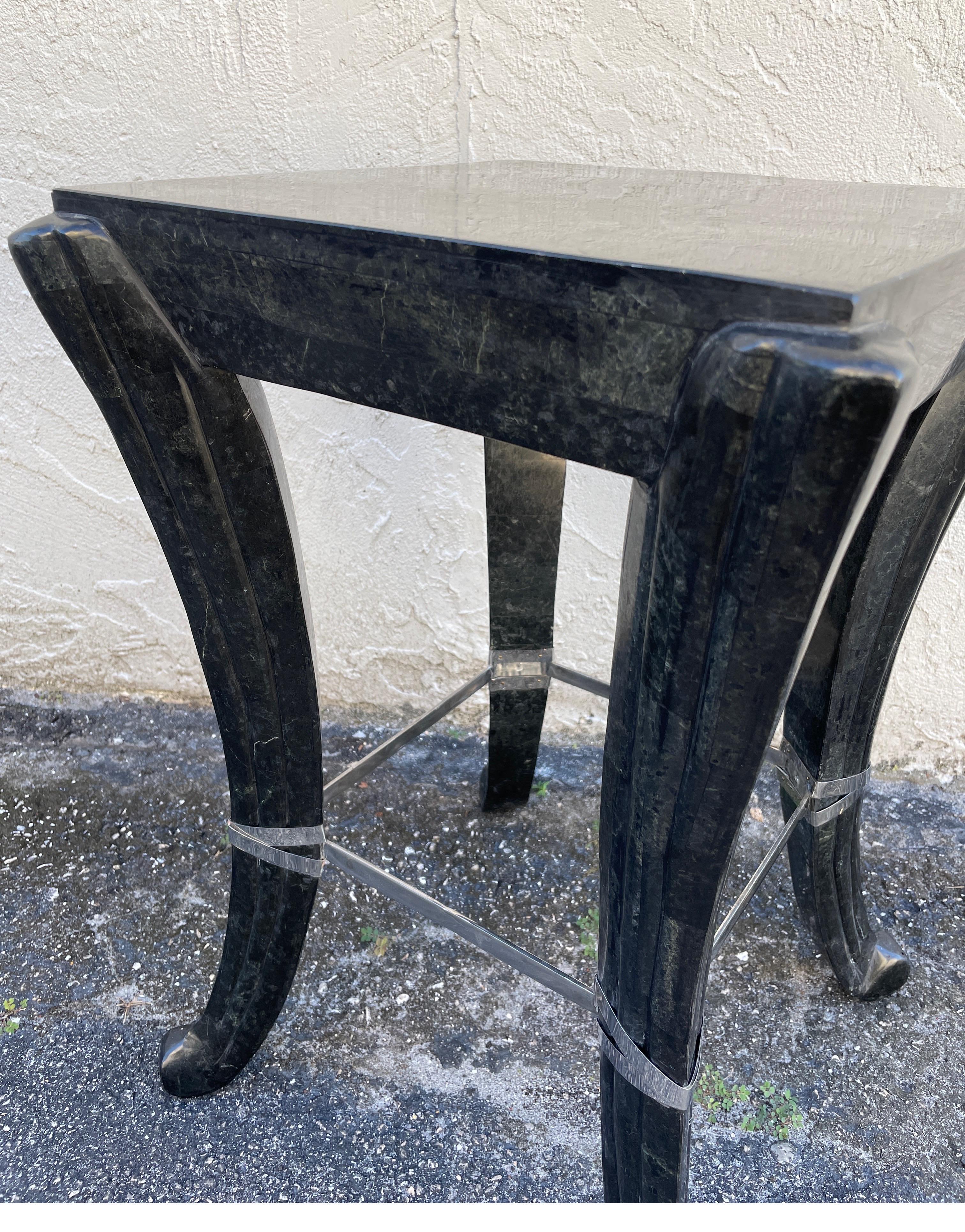 Art Deco style tessellated black marble drinks table with silver plate straps around legs.