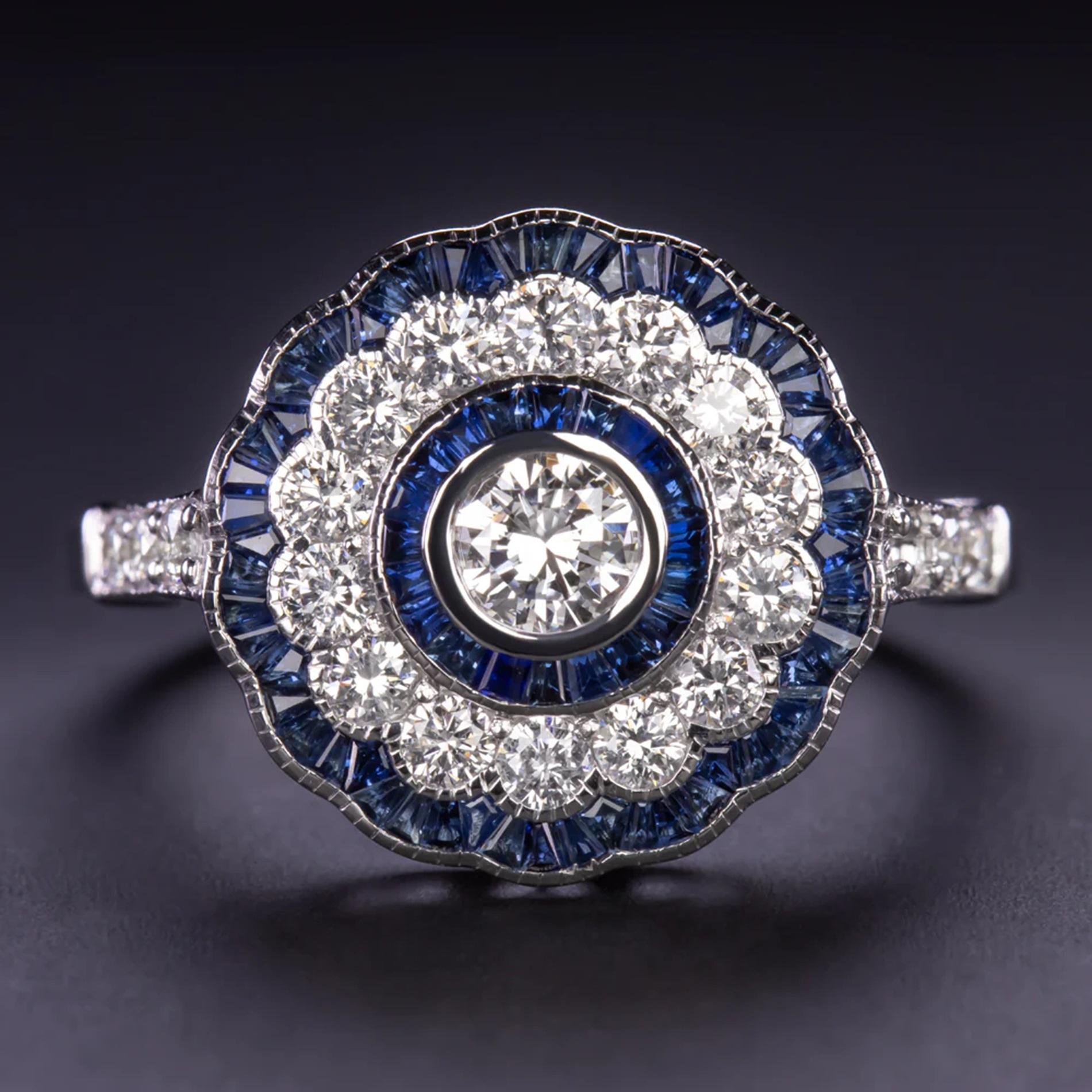 Introducing the timeless elegance of our Diamond and Sapphire Ring, meticulously crafted to embody the allure of the Art Deco era.

Discover the brilliance of the centerpiece, a 0.20ct round cut diamond, surrounded by a triple halo of natural