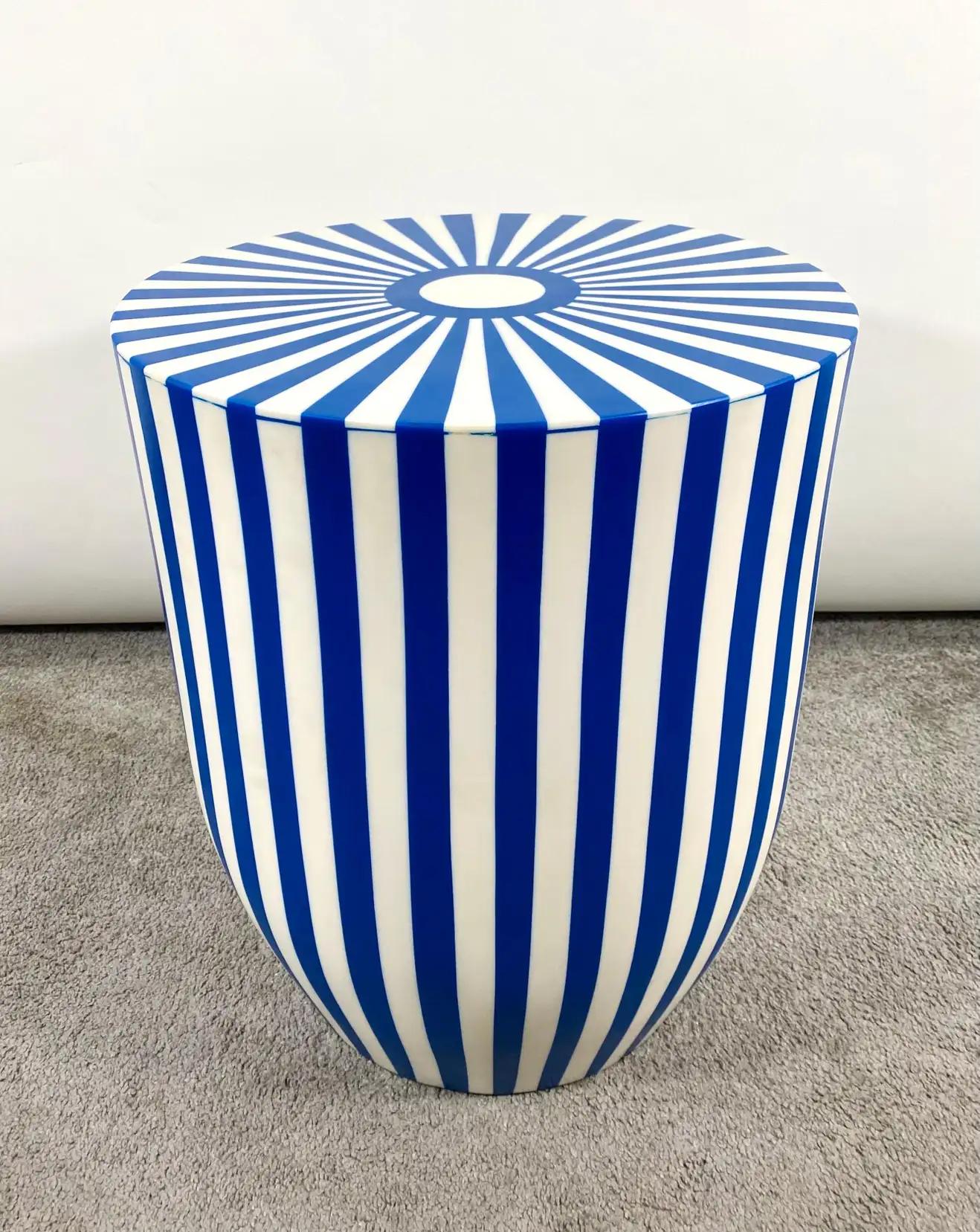 An exquisite Art Deco style blue and white side table or stool featuring a striped design. The table is made of quality resin and have a solid and sturdy structure. The sculptural cylindrical shaped table or stool has a round top and narrow base