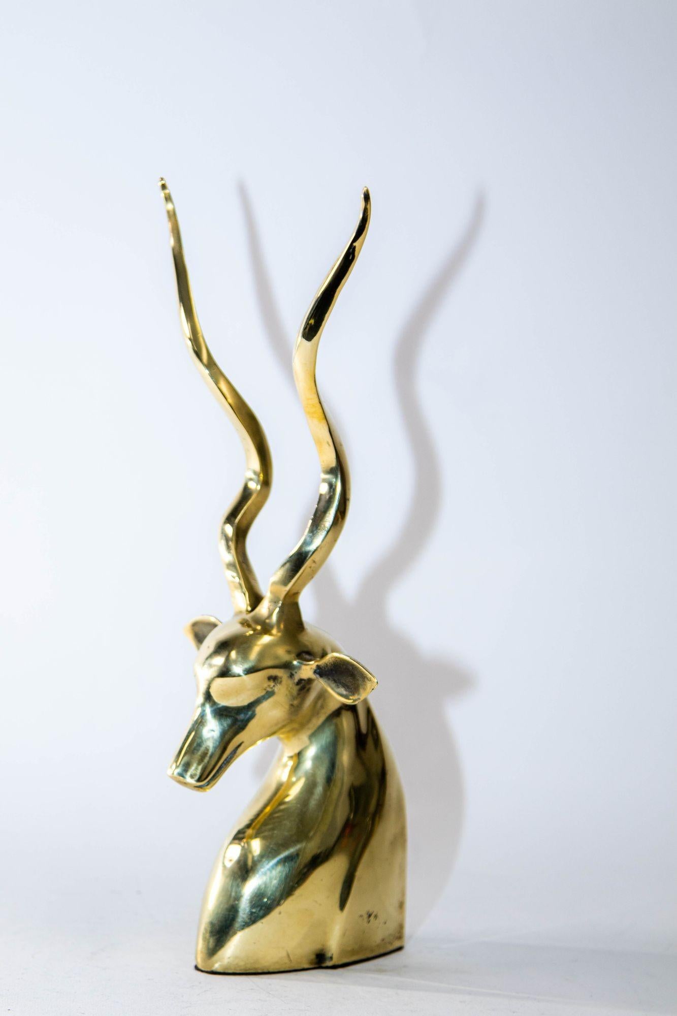 Art Deco style brass decorative antelope gazelle or kudu bust sculpture.
A brass animal Gazelle antelope bust sculpture decorative object with tall antlers.
Polished brass sculptural bust of an African Kudu antelope, similar to a gazelle, with tall