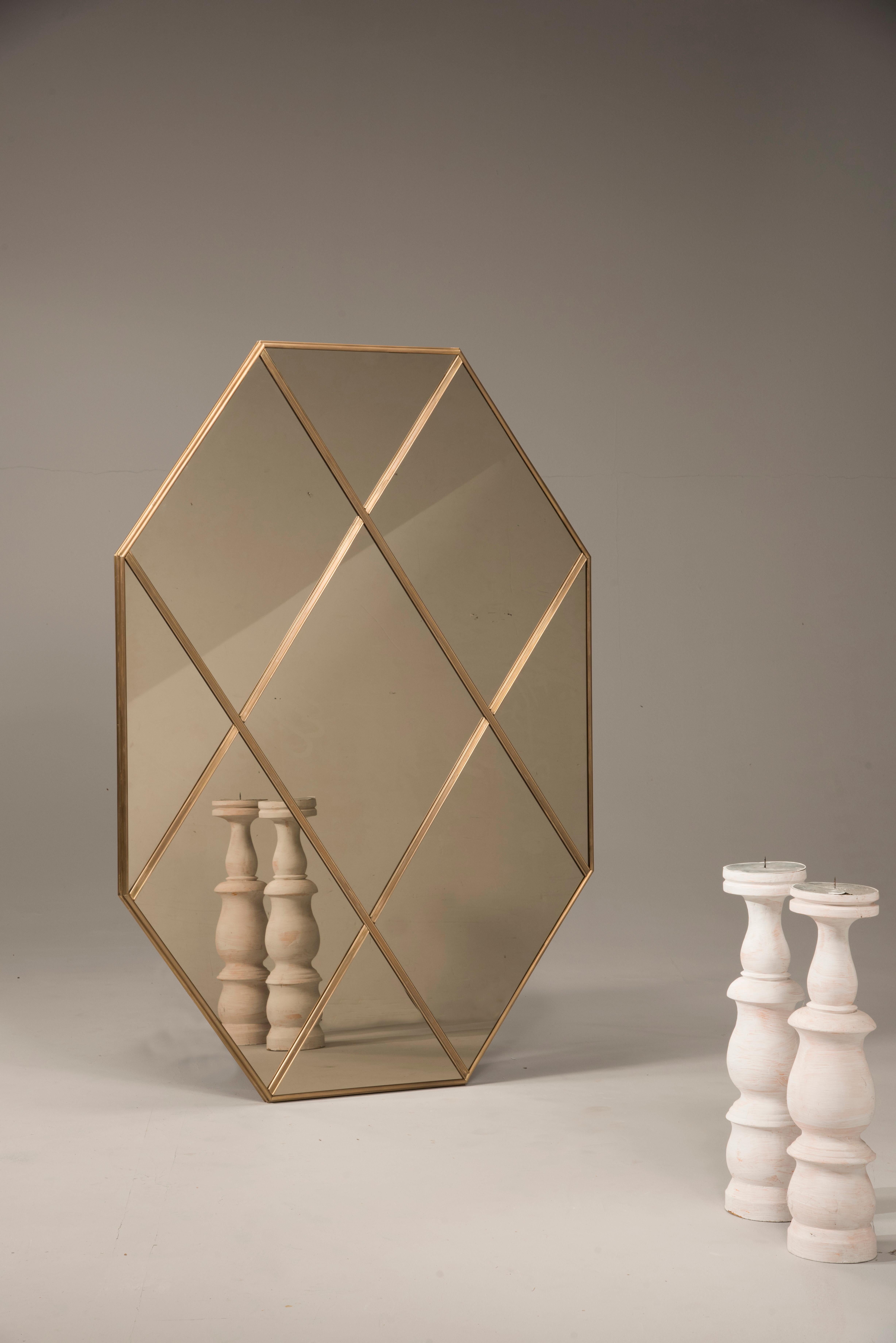 Pescetta presents its new collection of contemporary customizable mirror. Here, a brass frame, paneled bronze glass mirror. With frame made of brass, mitred corners and multi panels, these mirrors replicate the idea of early 20th century Art Deco