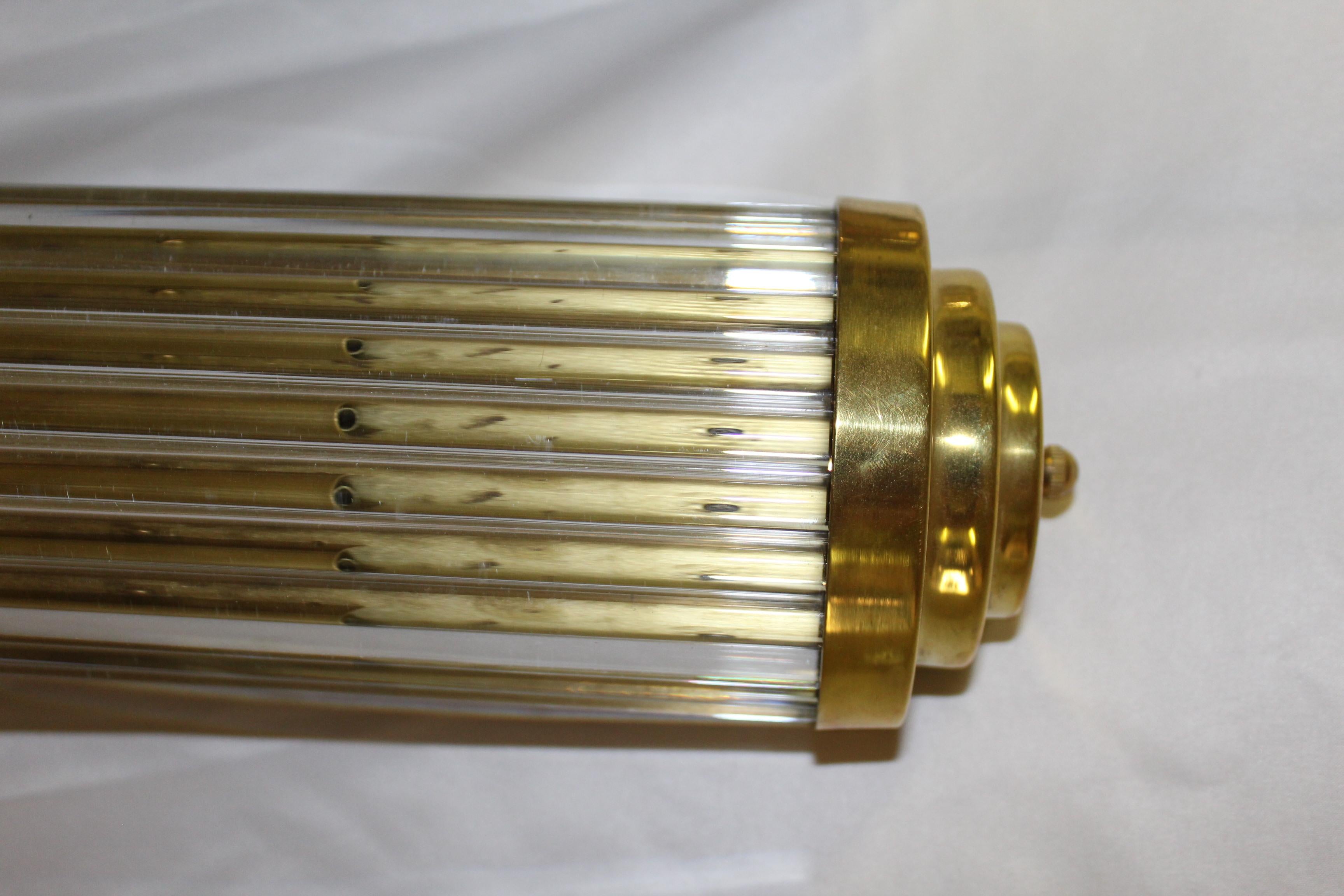 Deco sconces in solid brass metal with a hi-polished finish. handcut glass rods cut to fit. Made for a lighting showroom. Samples new/old stock. Has 4 candelabras. Can be mounted vertically or horizontally. Measures: 24 