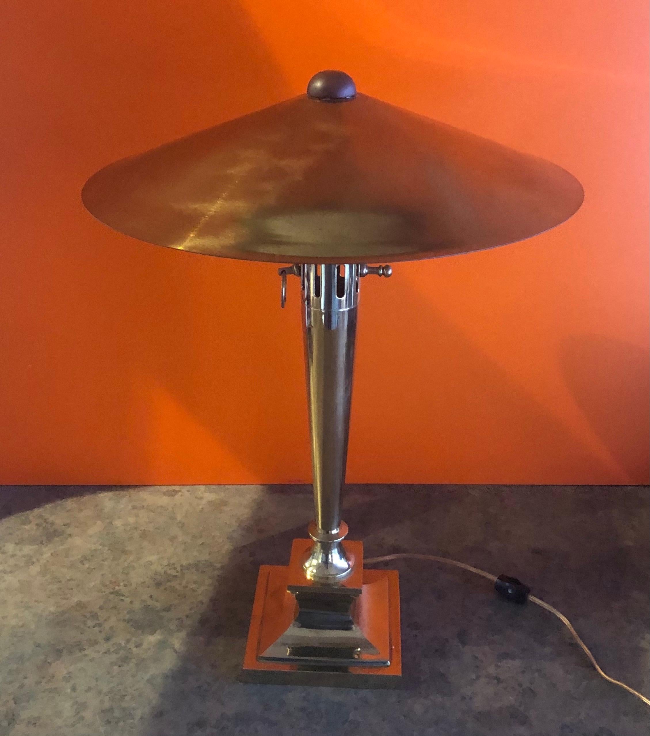 A very cool and unique Art Deco style brass table lamp with brass shade, circa 1970s. The lamp has heavy solid brass construction with a beautiful patina and measures 15