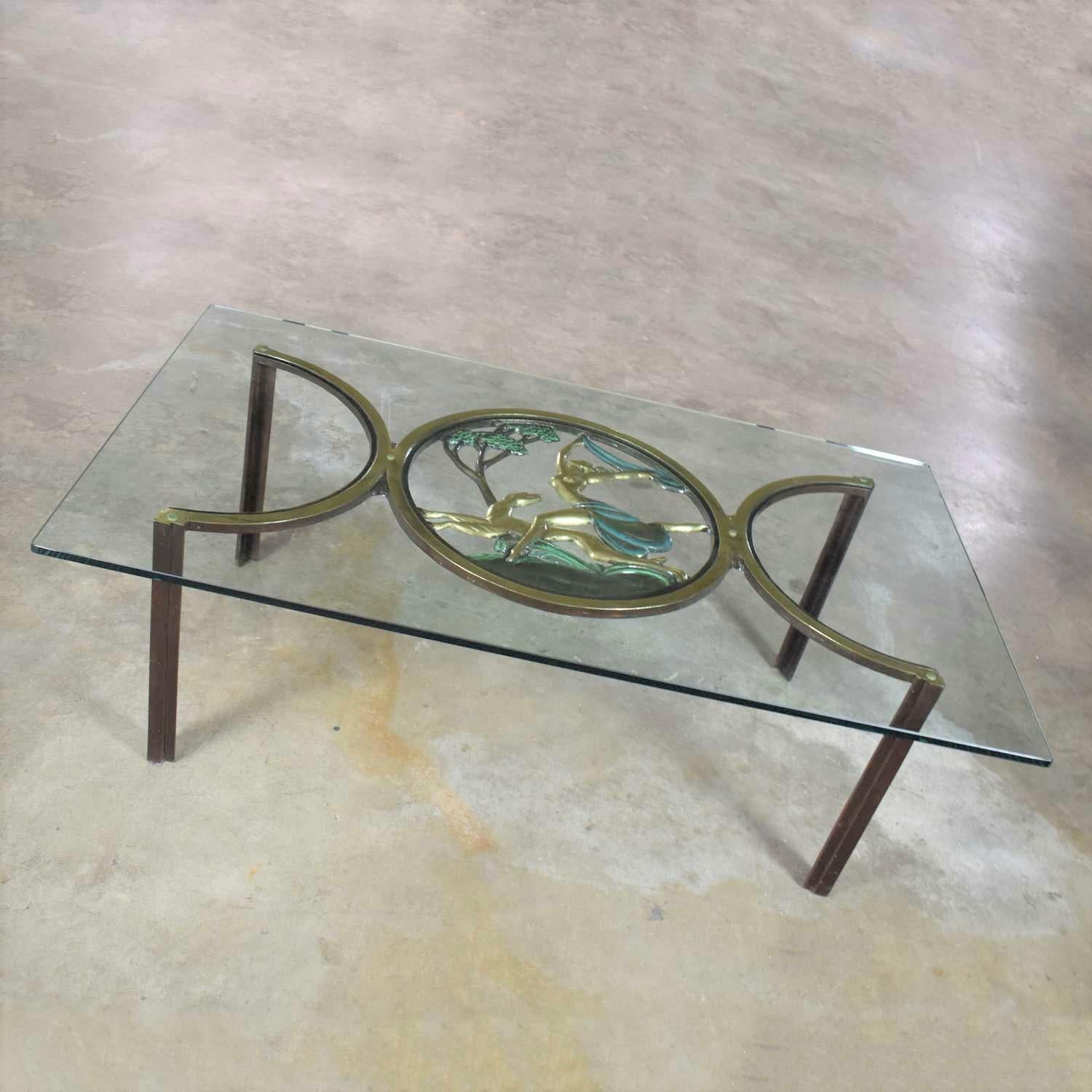 Amazing Art Deco style coffee table or cocktail table in bronze with a center medallion of Diana the Huntress and 5/8” glass top with radius corners. It is in wonderful vintage condition. The top may have small scratches. Please see photos, circa