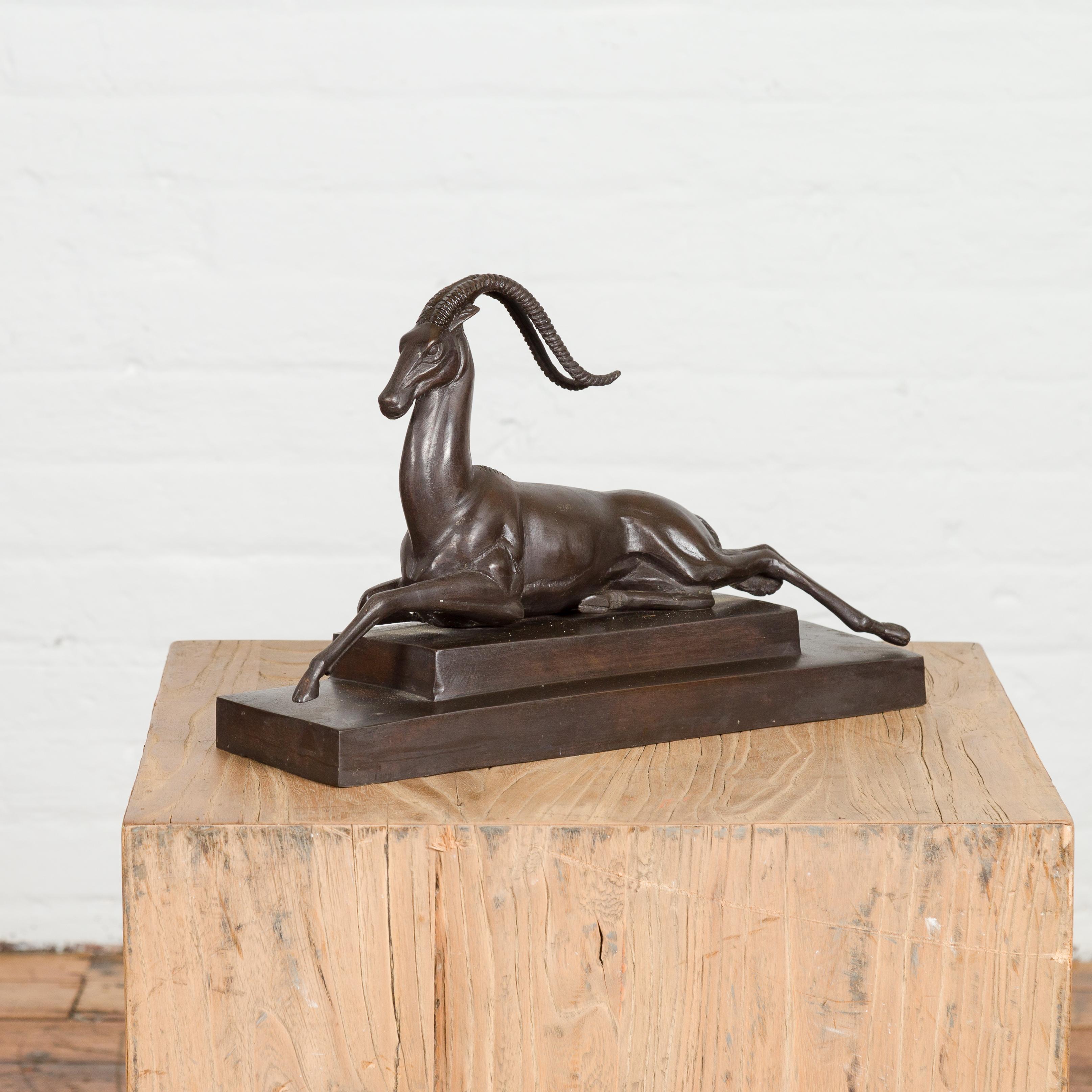 An Art Deco style bronze gazelle on stepped base after Pierre le Faguays in dark patina. Elevate your interior with this exquisite Art Deco-style bronze gazelle sculpture, reminiscent of the iconic works by the renowned artist Pierre le Faguays.