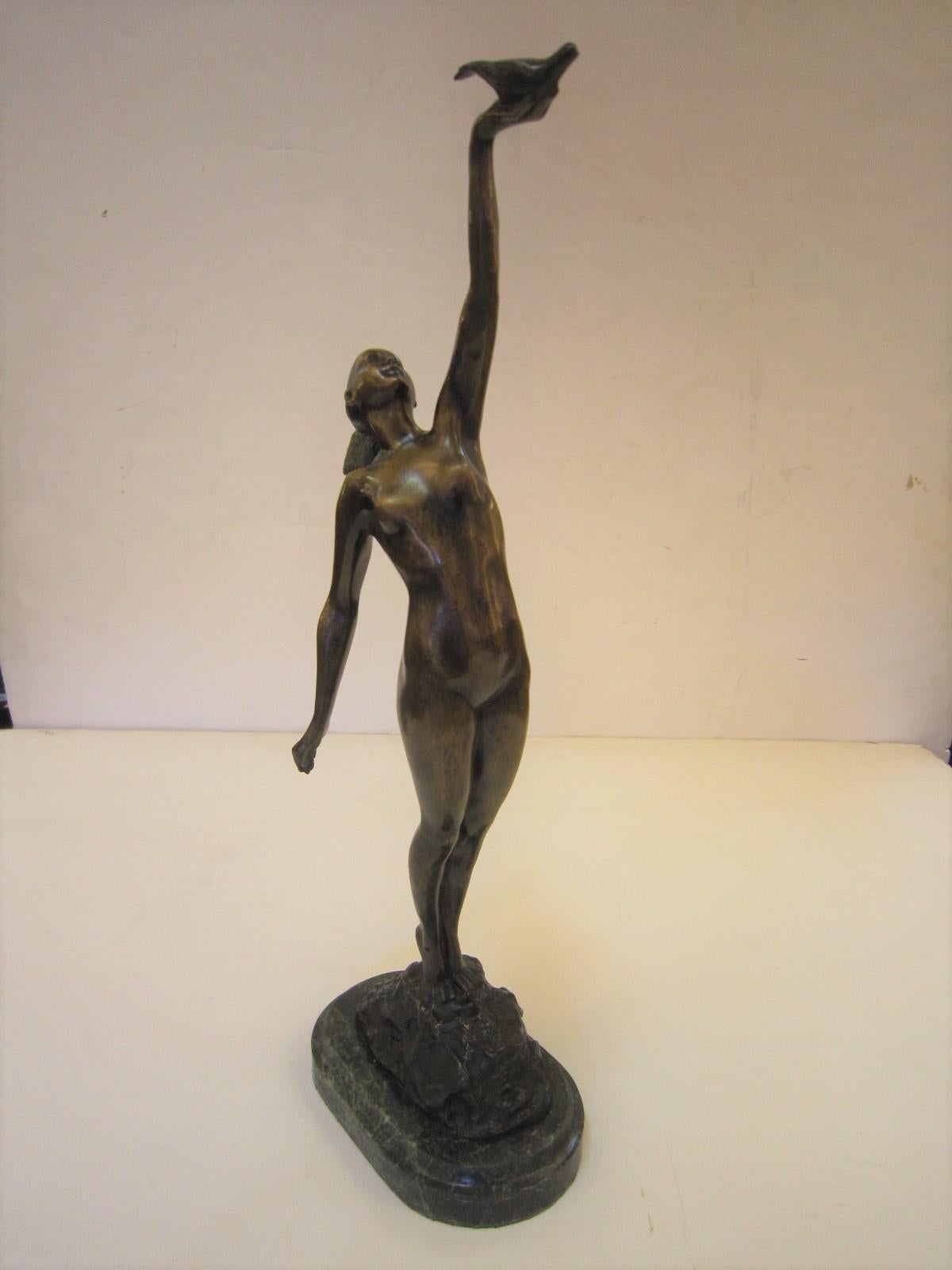 Art Deco style bronze statue of a nude woman standing on a rocky outcrop with arm upward holding a dove.
Resting on a verde green marble base.
Susse Freres stamp.
  