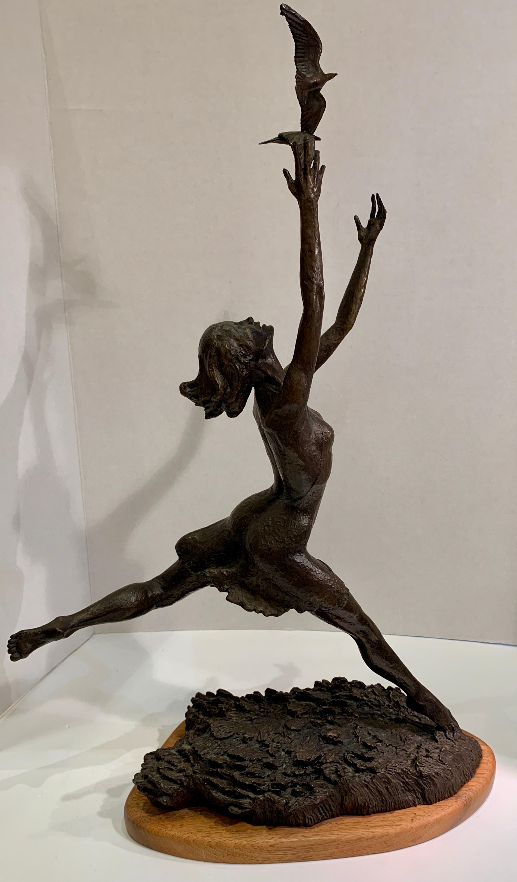 A beautiful and graceful, Art Deco style patinated bronze sculpture of a sinuous, barefoot dancer, with her head thrown back, joyfully leaping into the air with her arms outstretched, her fingertips reaching for and touching a pair of seagulls or