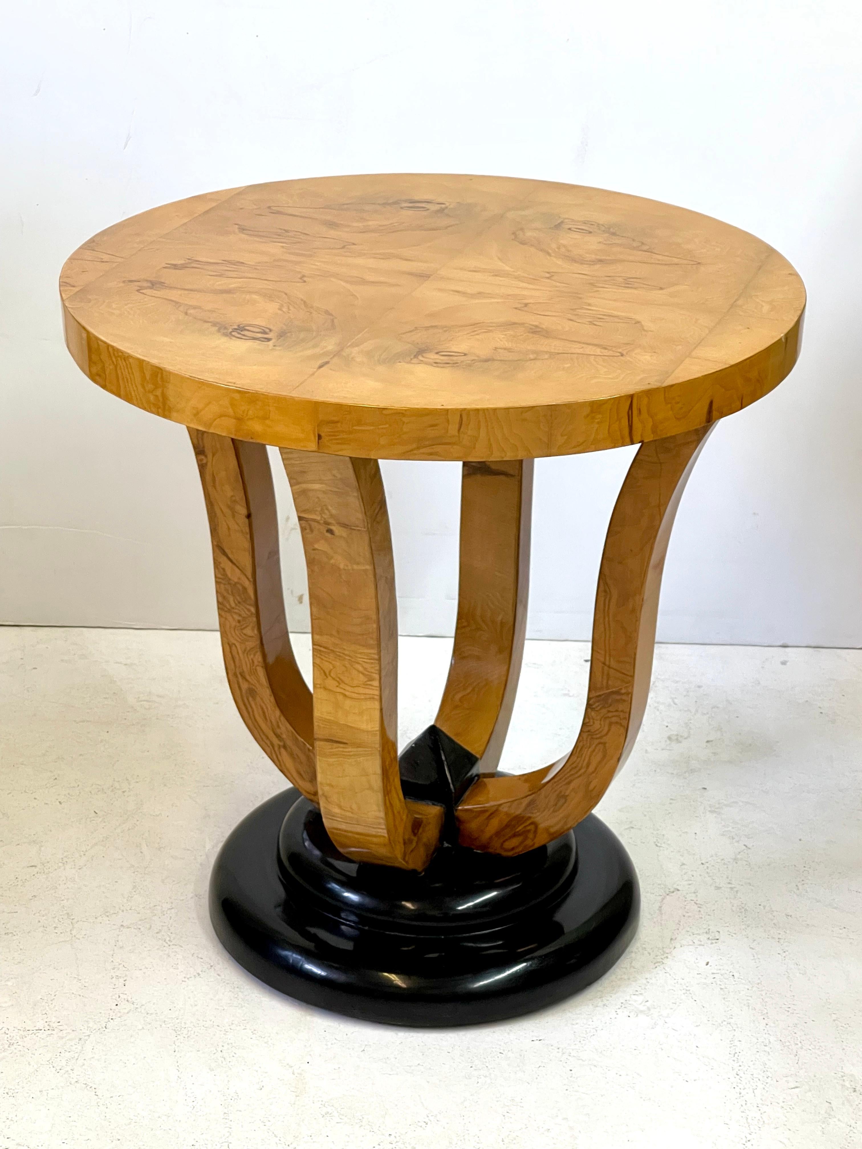 20th Century Italian Art Deco style gueridon table in burled wood veneer having a beautifully designed, book-matched top over a tulip form base. The four legs taper down to a stepped platform and a decorative center accent that have been