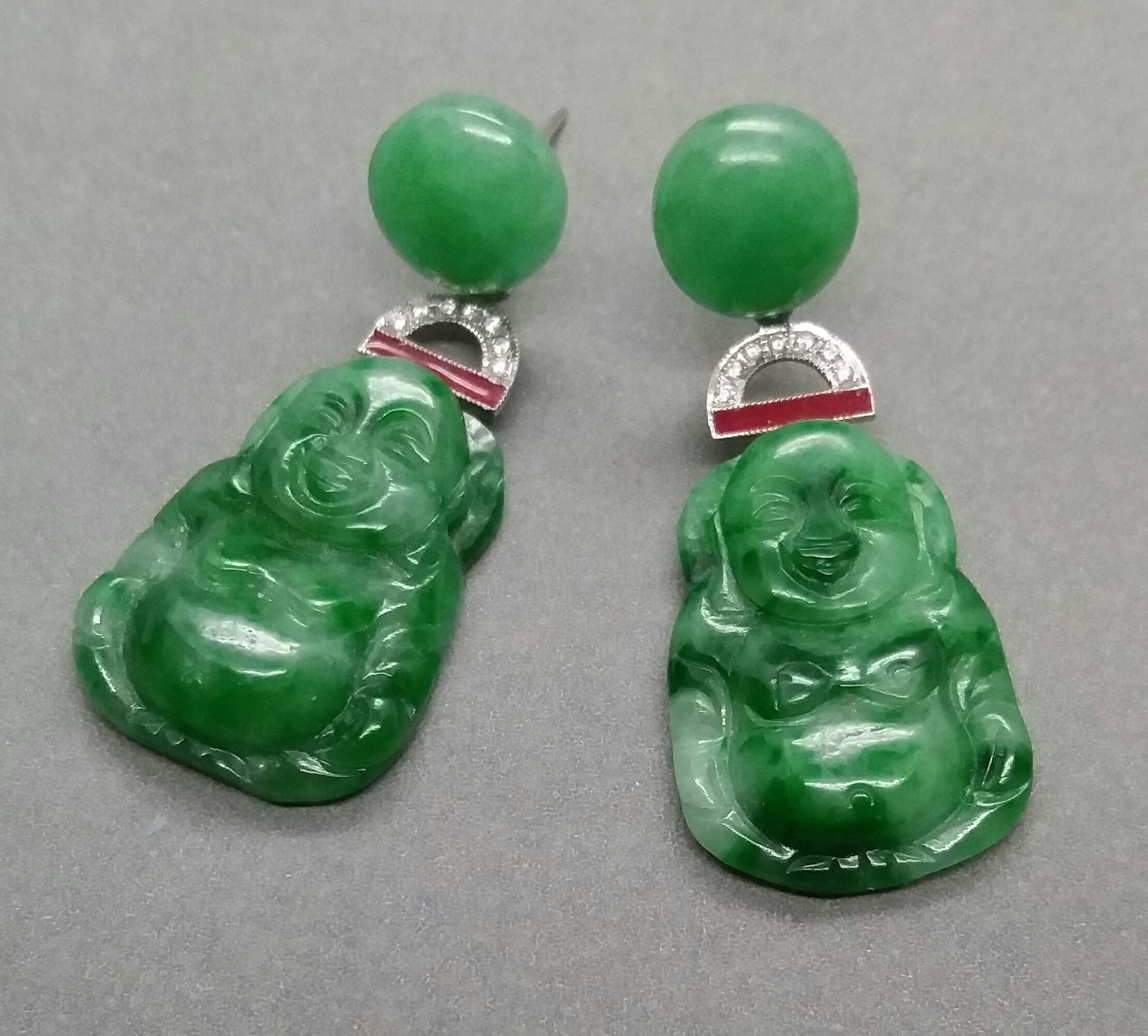 Art Deco Style earrings with 2 round Burma Jade buttons tops ,central parts in white gold,14 round full cut diamonds,red enamel and bottom parts composed of 2 Burma Jade Buddhas

In 1978 our workshop started in Italy to make simple-chic Art Deco