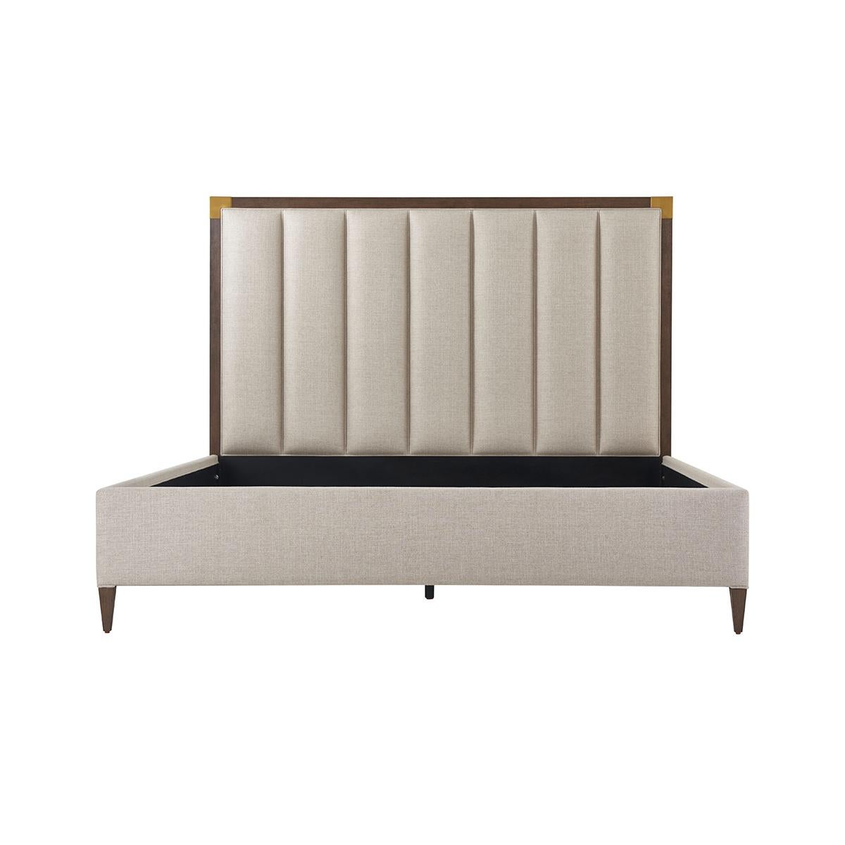 With a Cardamon finish frame and brushed brass finish corner mounts with a vertically channeled upholstered headboard, upholstered rails and raised on tapered legs.

Dimensions: 76.25