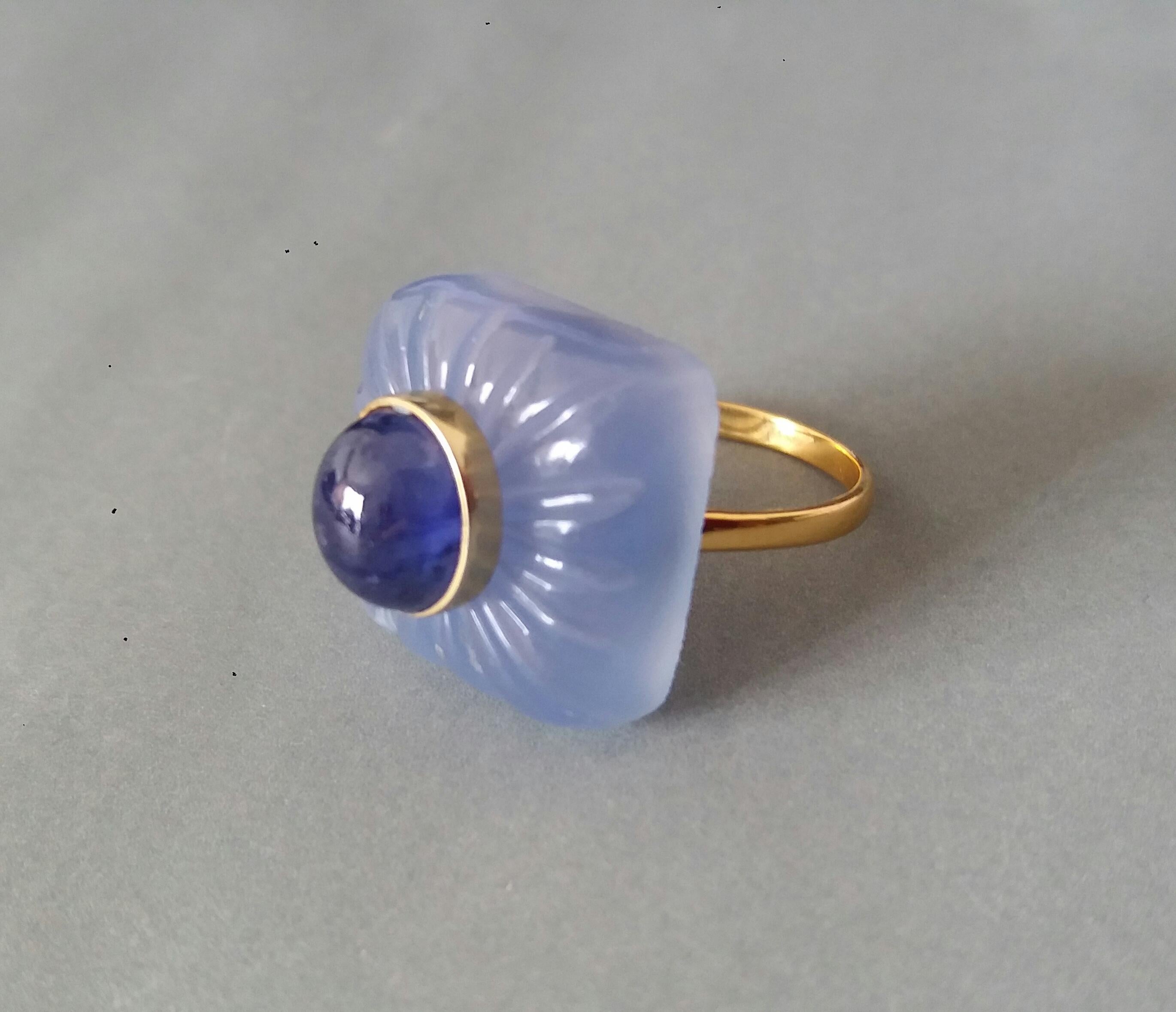 Classic and elegant ring composed of a engraved Blue Chalcedony Cushion Cabochon measuring 19x19mm  surmounted by a Oval Blue Sapphire Cabochon measuring 7x9mm set in a 14k yellow gold bezel...The shank  is also in 14k  solid Yellow Gold 

In 1978
