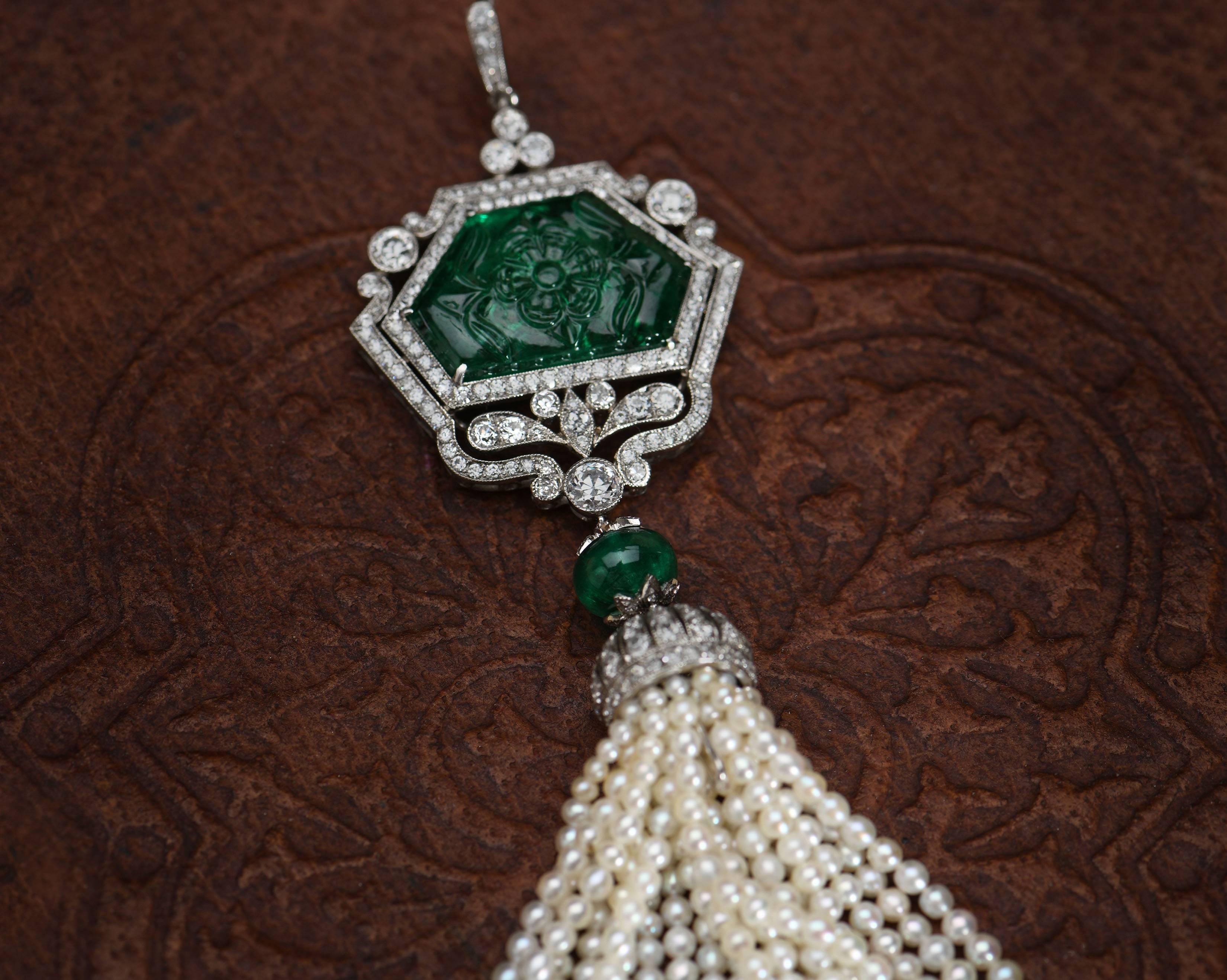 A wonderful, stunning head-turner. This pendant has it all with a big beautiful stone, fine craftsmanship and fantastic design.

The main focus of the piece is the magnificent carved emerald surrounded by diamond encrusted platinum in an Art Deco
